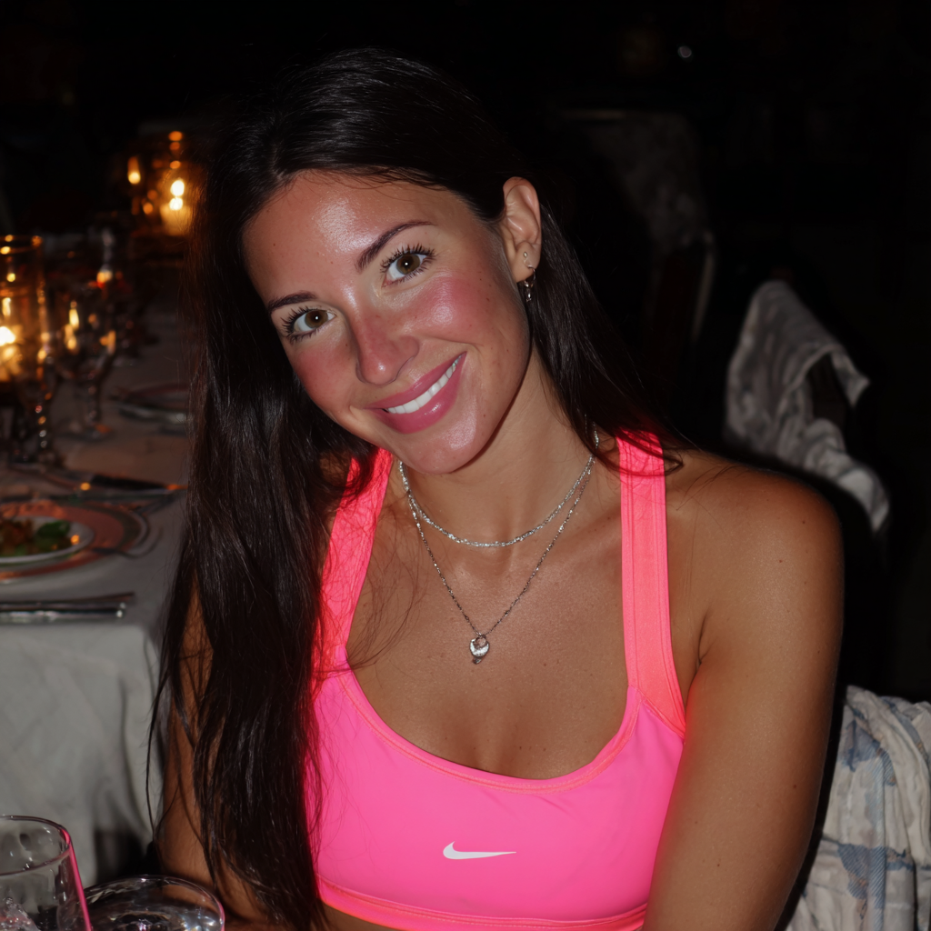 A smiling woman sitting at a table | Source: no source