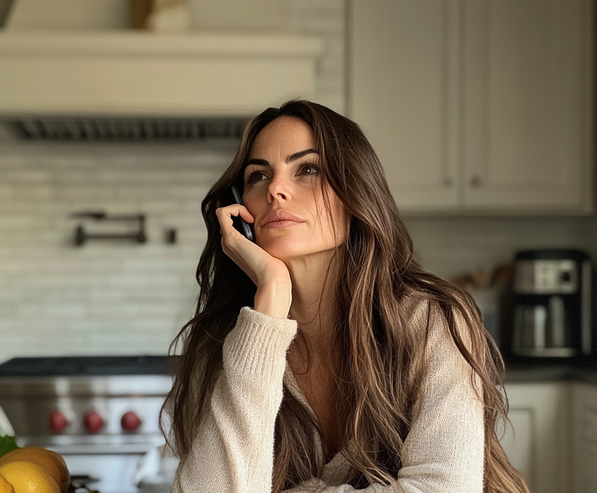 A woman sitting at her kitchen counter | Source: No source