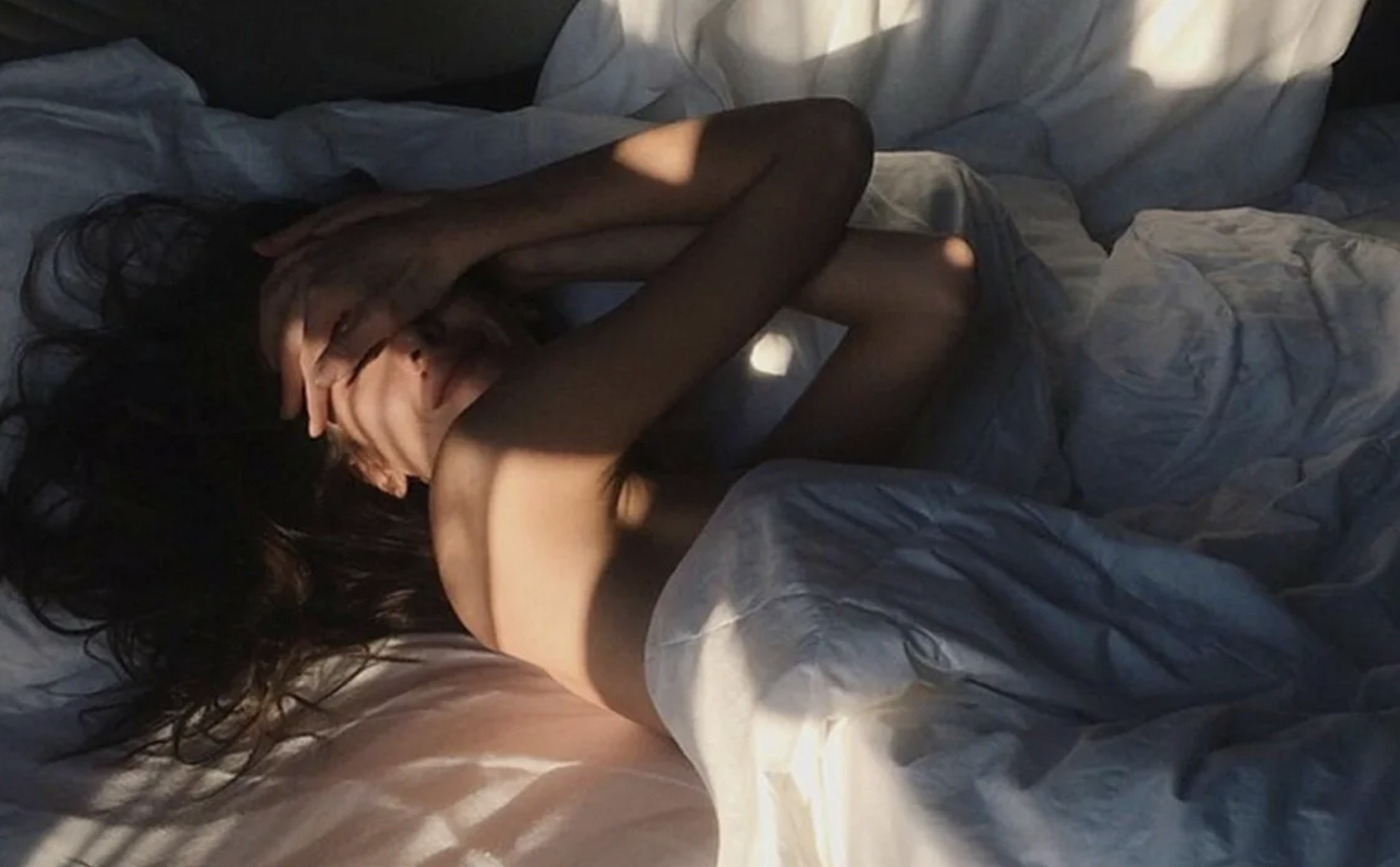 Woman is waking up in bed | Source: Shutterstock