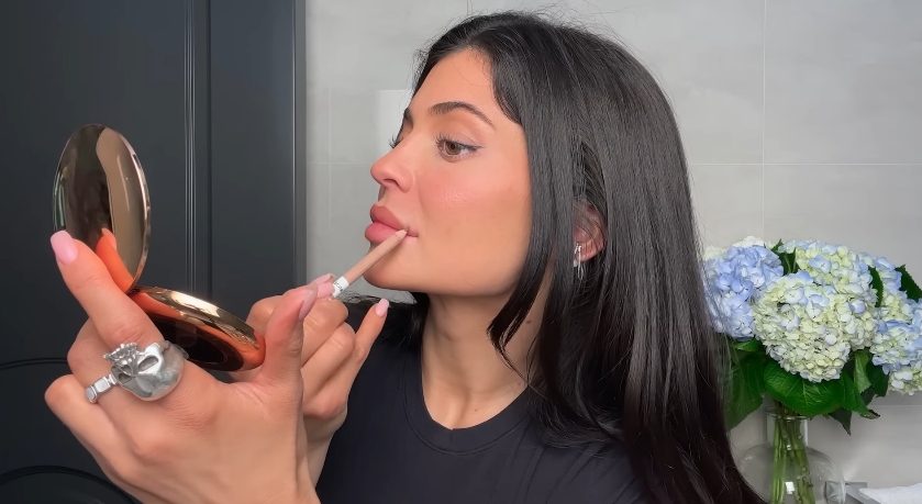 Kylie Jenner doing her classic beauty routine from a video dated April 6, 2023. | Source: YouTube/Vogue