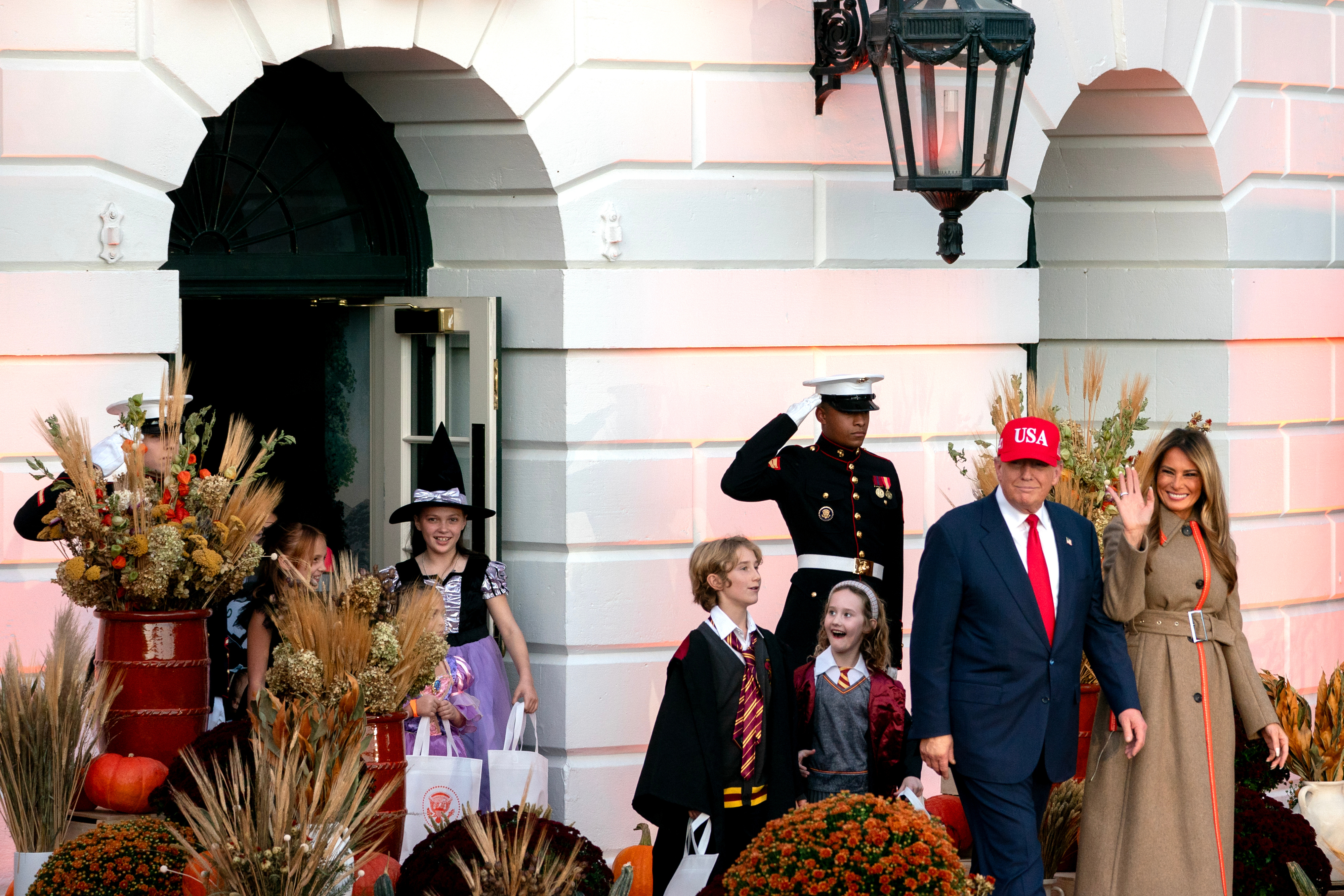 US President Donald Trump, second right, and First Lady Melania Trump, right, arrive for a Halloween event on the South Lawn of the White House on October 30, 2025, in Washington, D.C. | Source: Getty Images