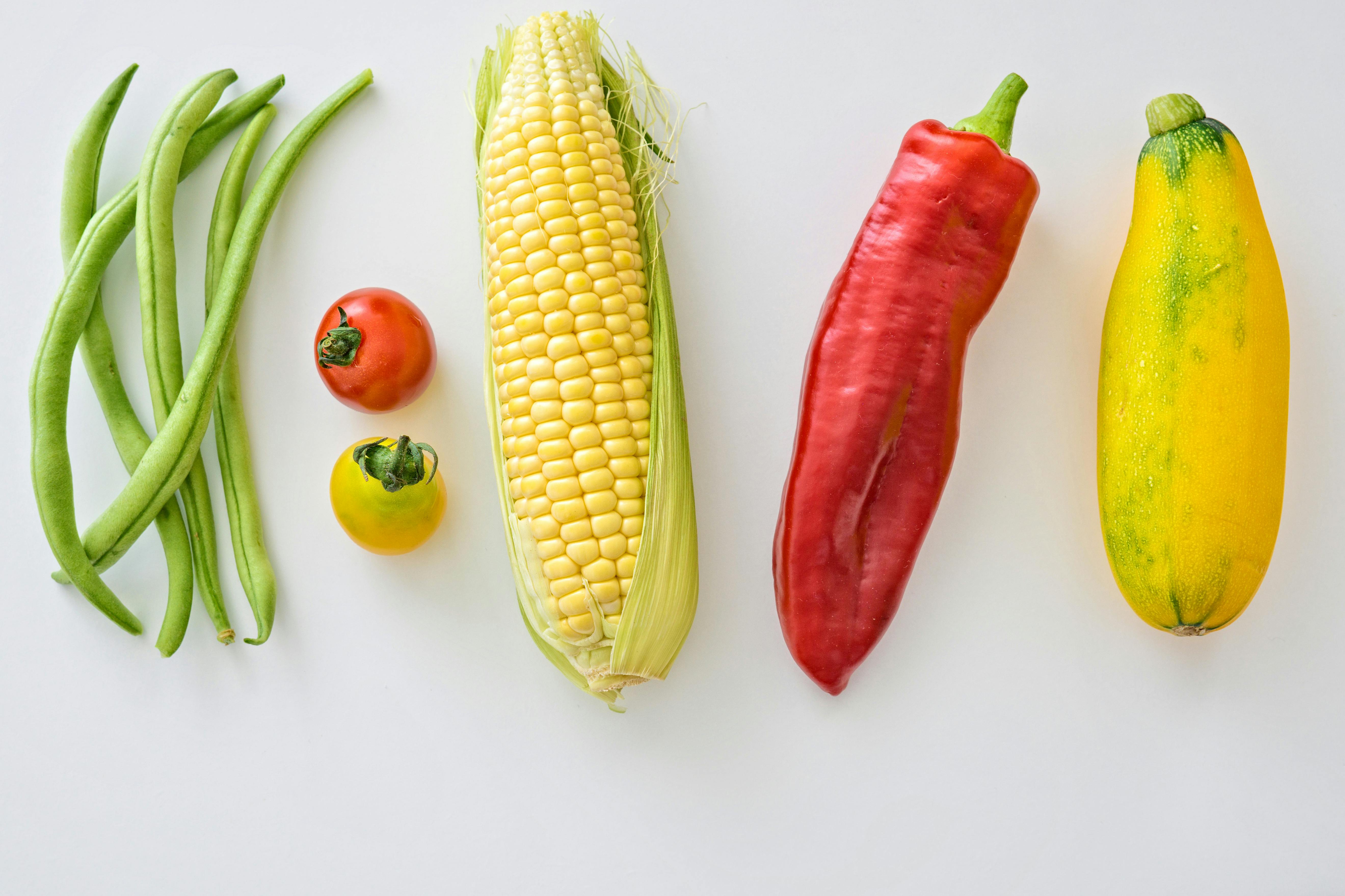Assortment of five vegetables on a white surface | Source: Pexels