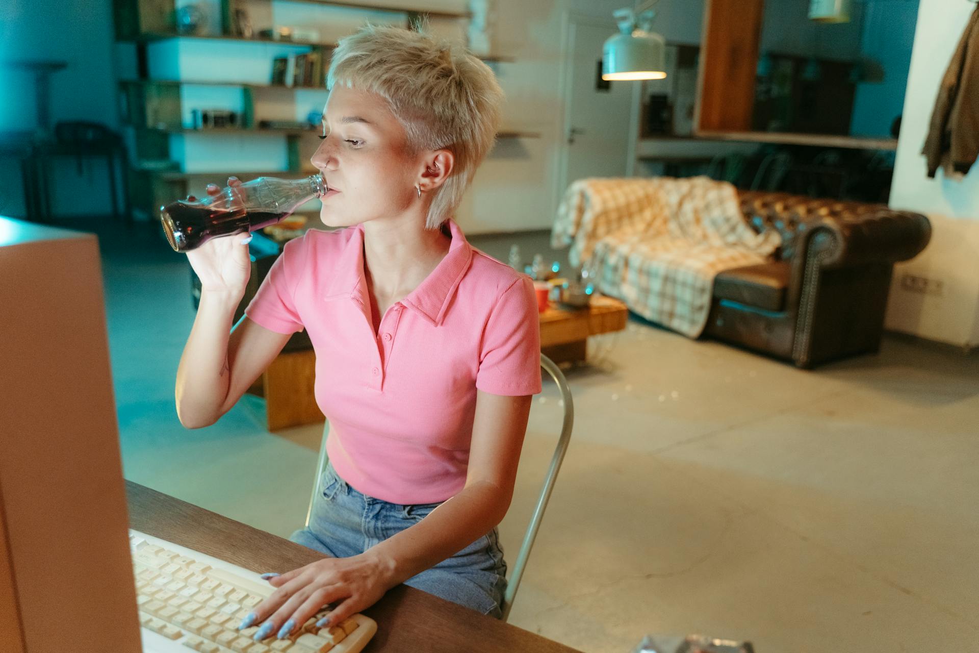 Woman working and drinking soda | Source: Pexels