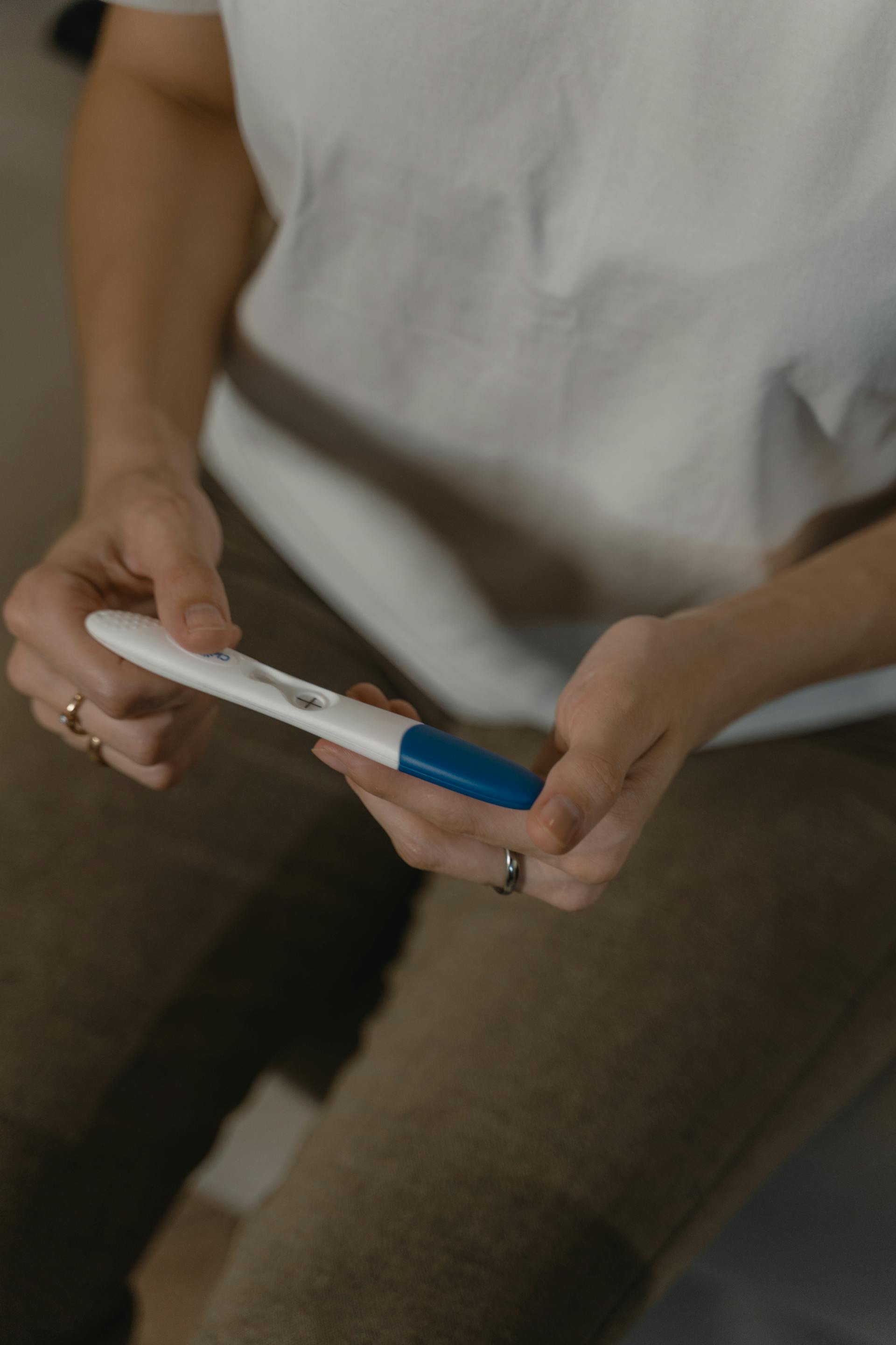 Close-up of a woman holding a pregnancy test kit | Source: Pexels
