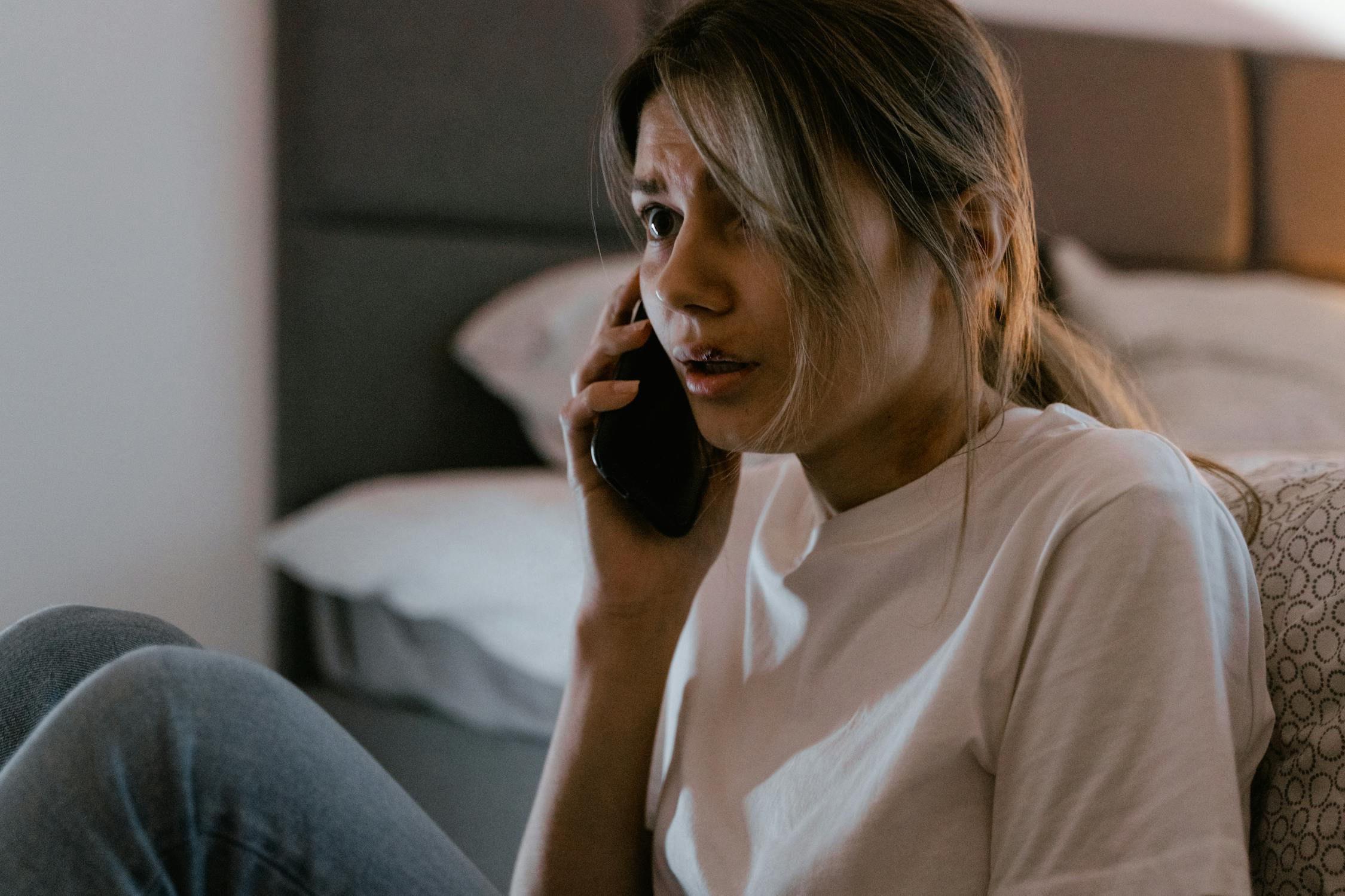 A nervous woman talking on her phone | Source: Pexels