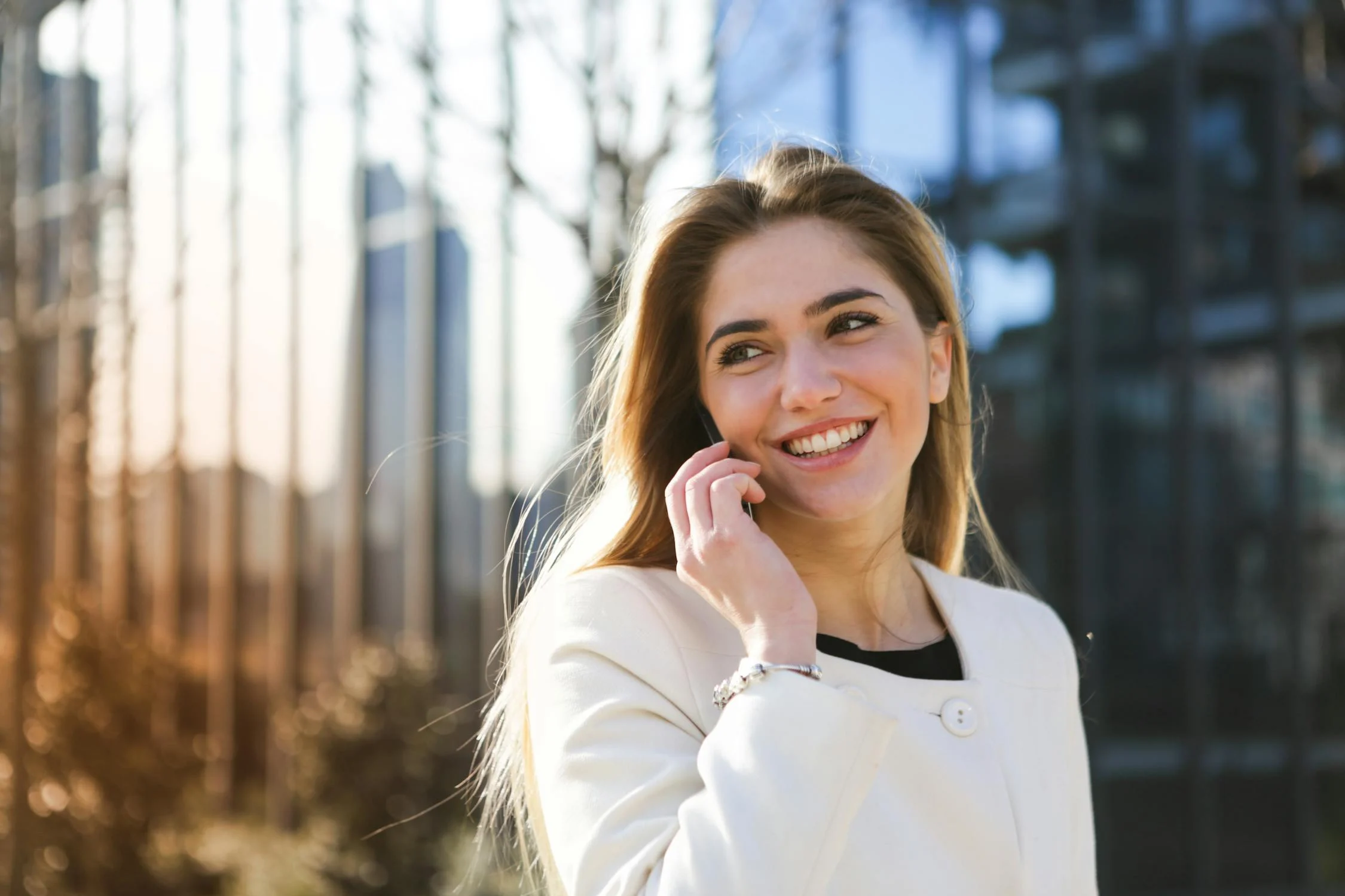 A laughing woman talking on her phone | Source: Pexels