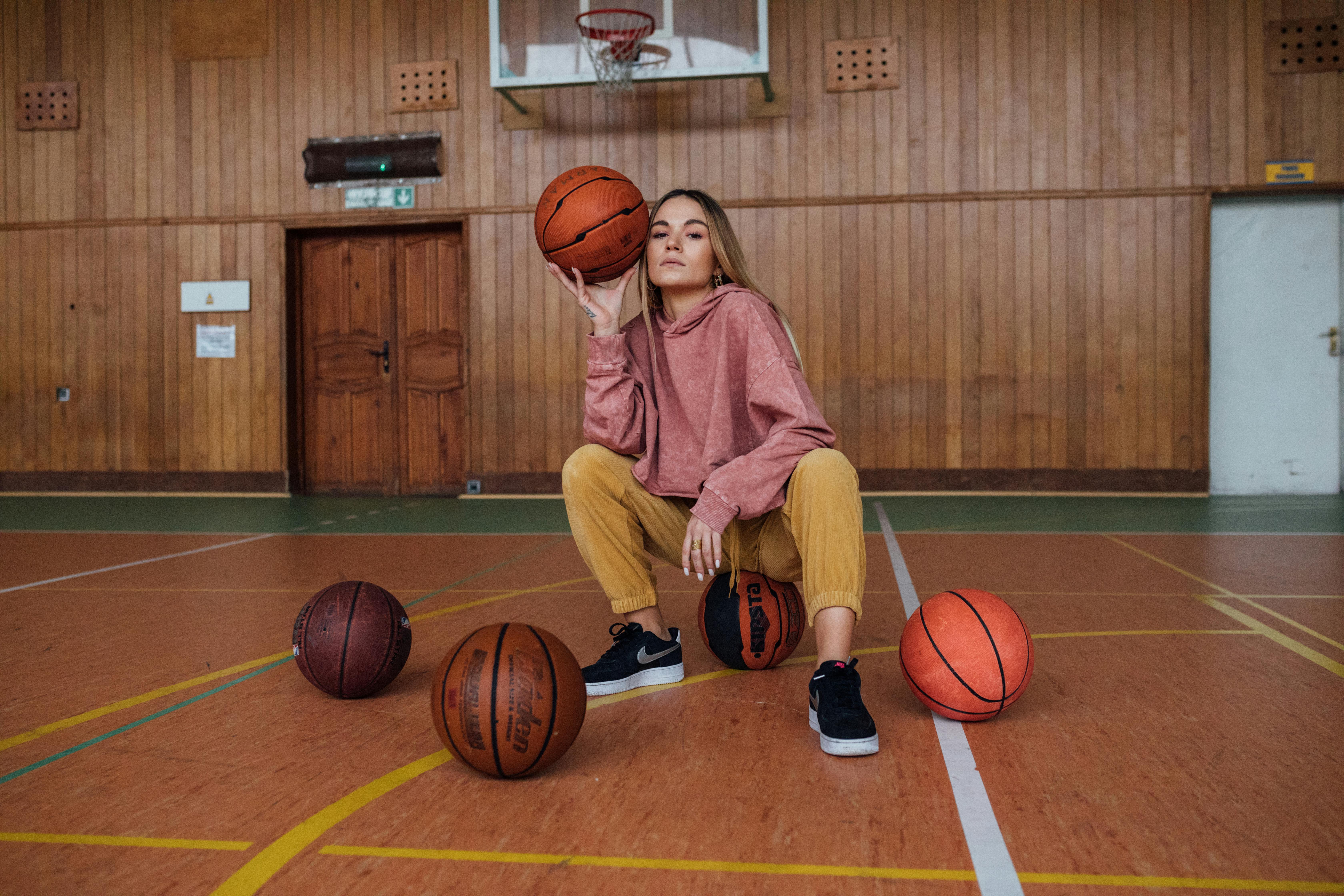 Woman with basketballs | Source: Pexels
