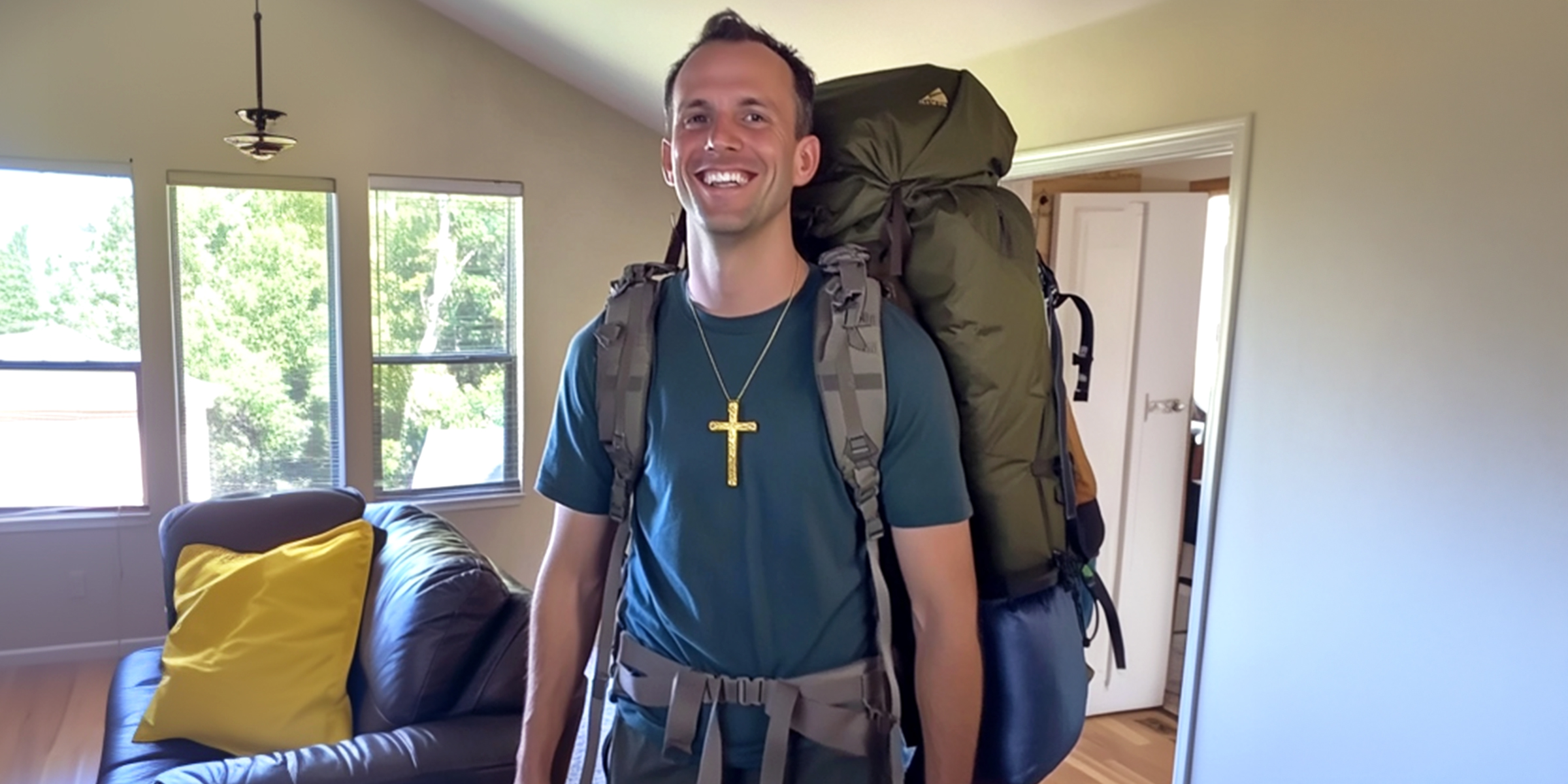 A happy man with his camping gear | Source: No source