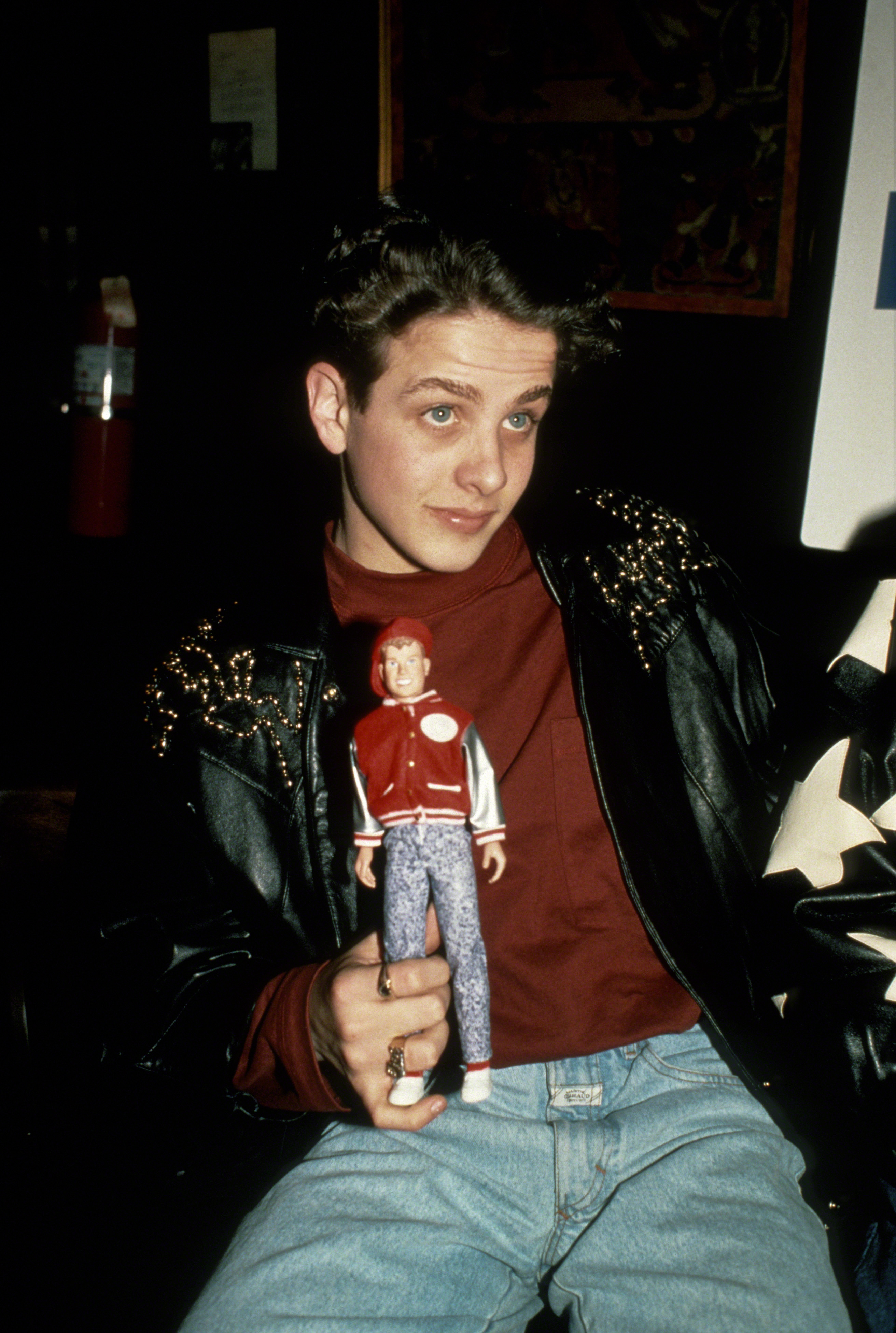Joey McIntyre posing with merchandise during a NKOTB promotional appearance in New York City circa 1989. | Source: Getty Images