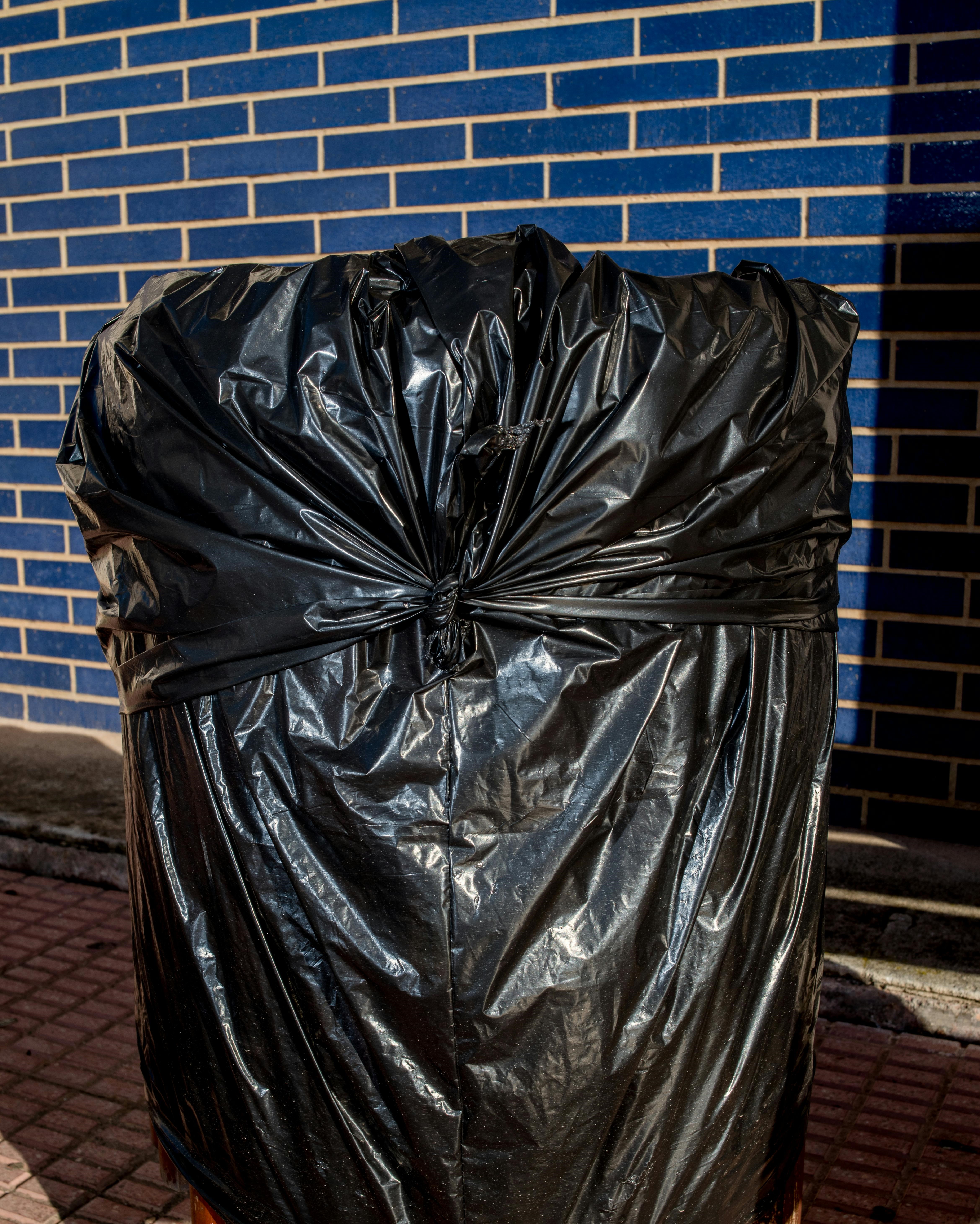 A black trash bag filled with items | Source: Pexels