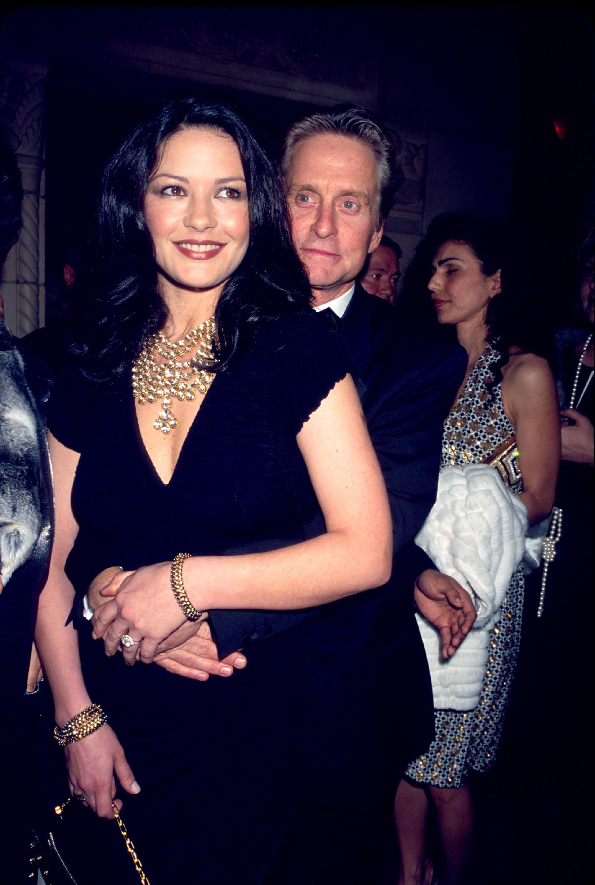 Michael Douglas embracing Zeta-Jones, who's wearing a deep V-cut dress and layers of gold jewelry, during the 17th Annual Night of Stars in New York City on October 24, 2000.