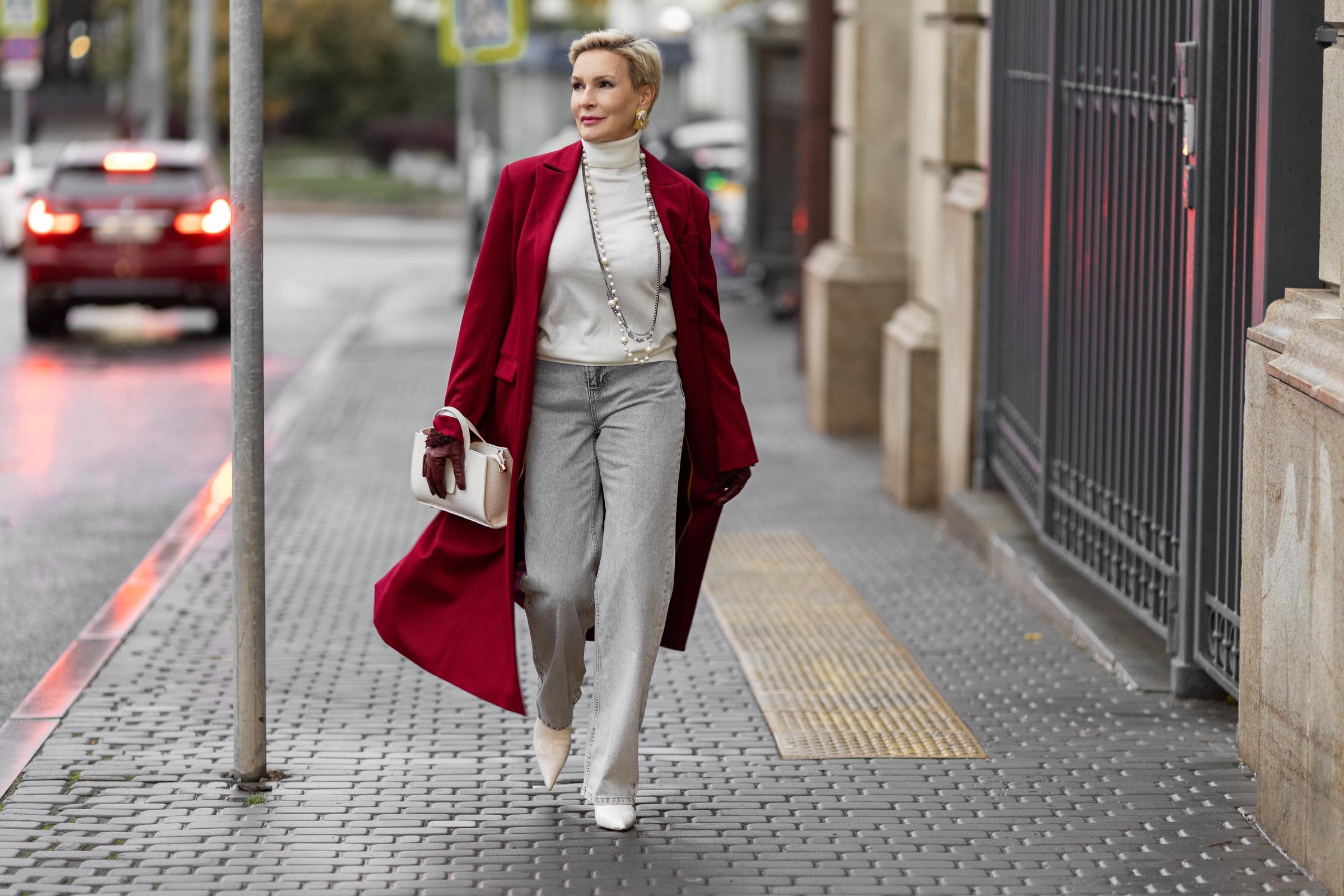 Stylish woman wearing a burgundy trench coat | Source: Shutterstock