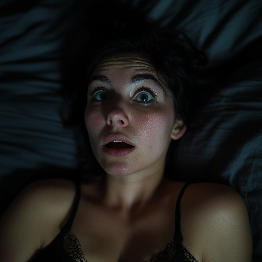 A shocked woman in her bed | Source: No source