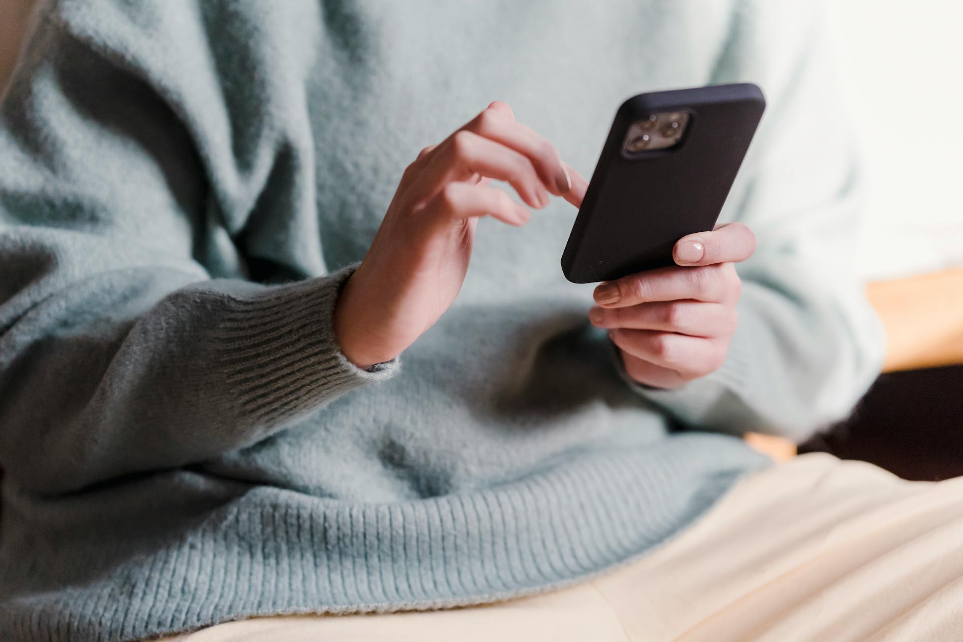 Cropped shot of a woman using her phone | Source: Pexels