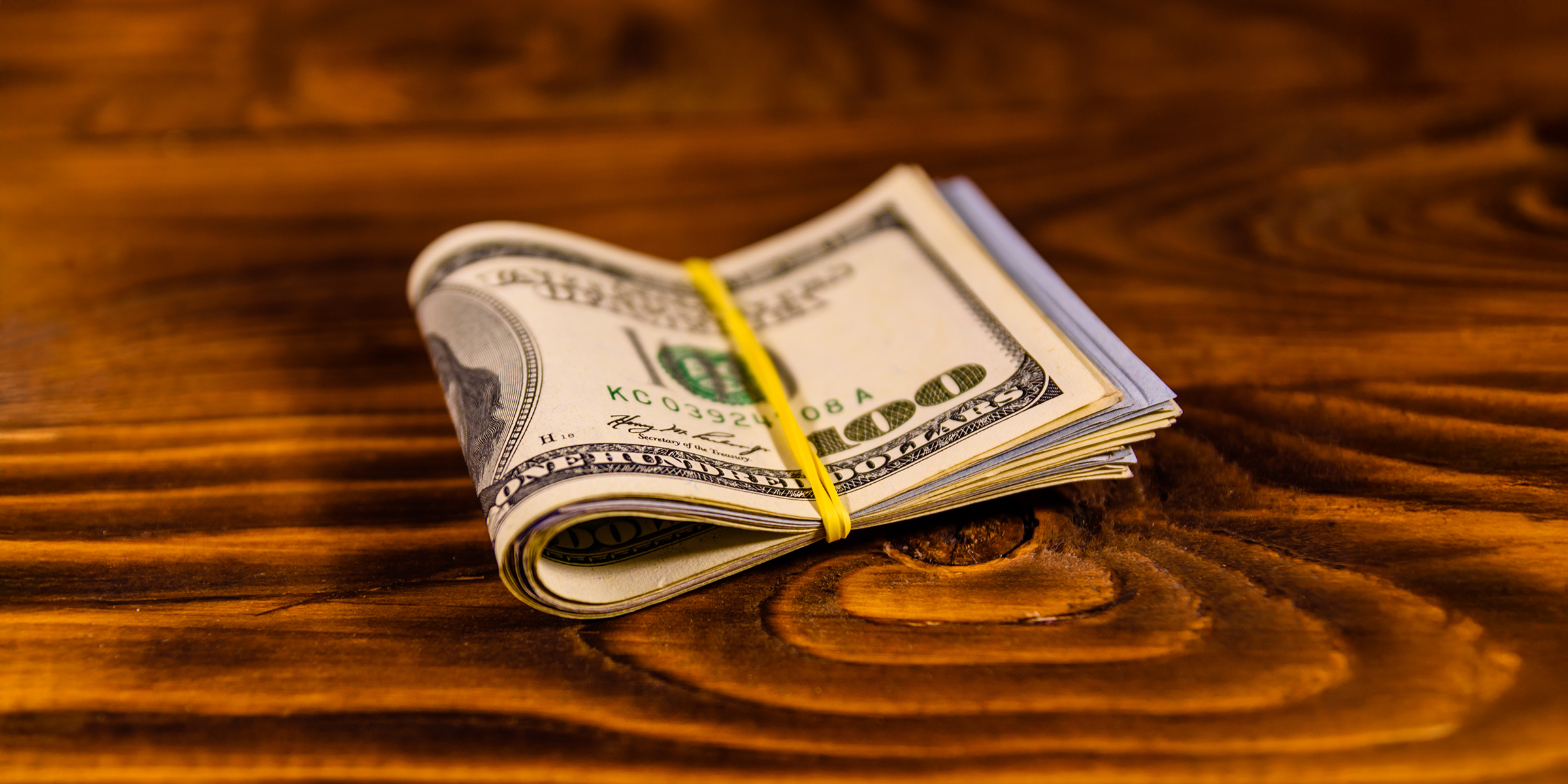 Dollar bills on a table | Source: Shutterstock