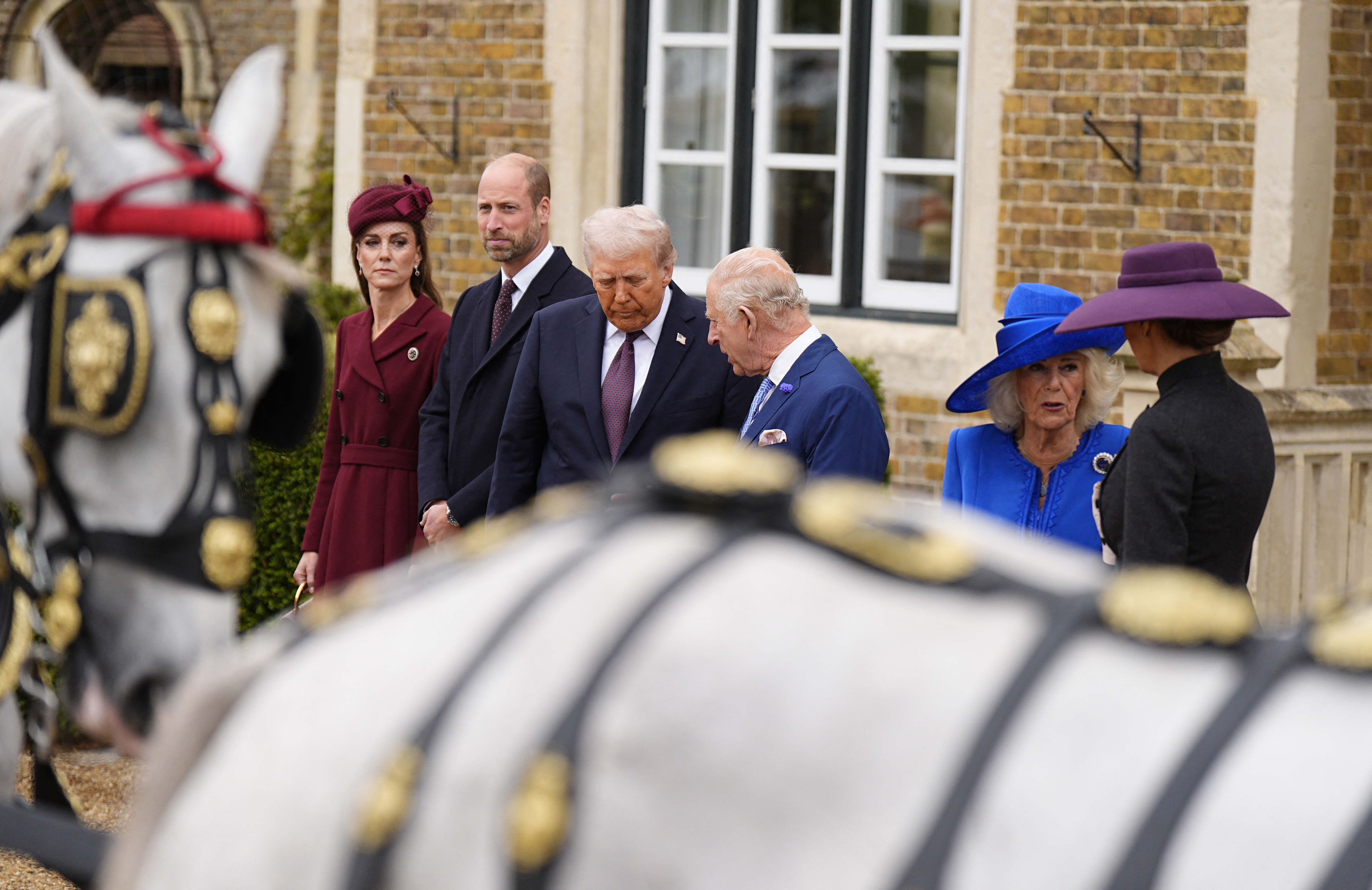 Britain's King Charles III talks with US President Donald Trump, as Queen Camilla talks with First Lady Melania while they wait for carriages, after their arrival at Windsor Castle in England on September 17, 2025 | Source: Getty Images