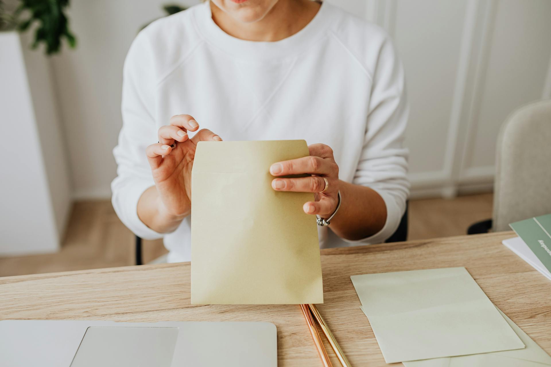 A woman removing a letter from an envelope | Source: Pexels