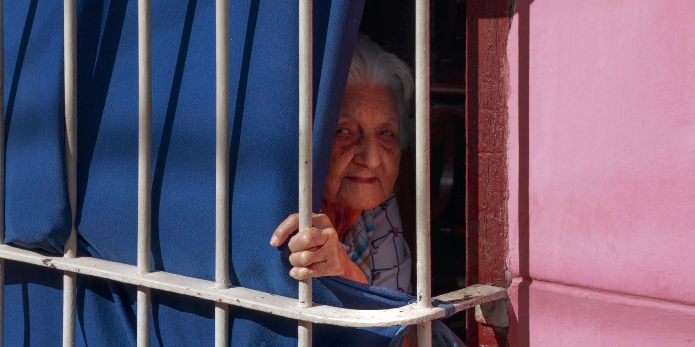 An elderly woman looking out the window | Source: Pexels