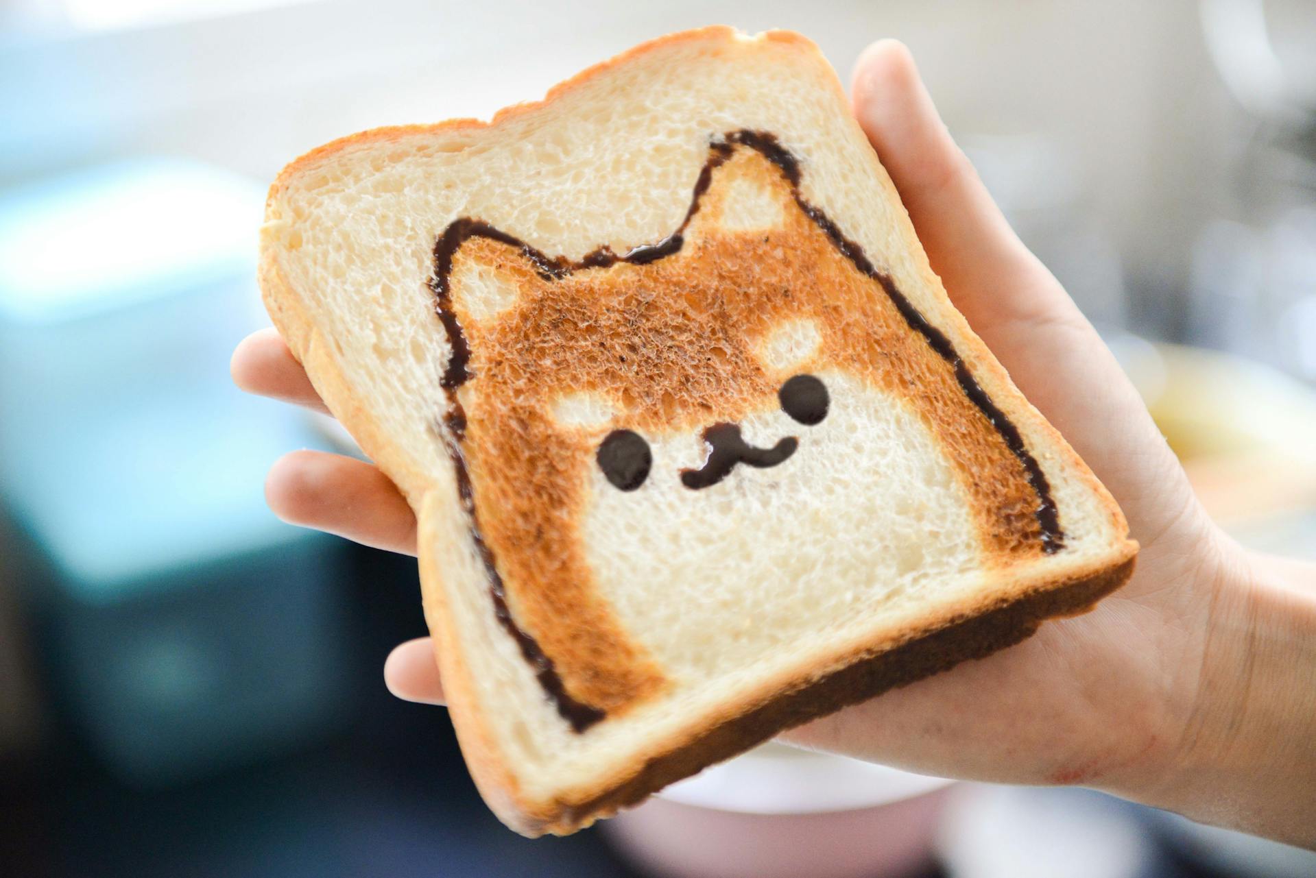 A person holding a slice of toast | Source: Pexels