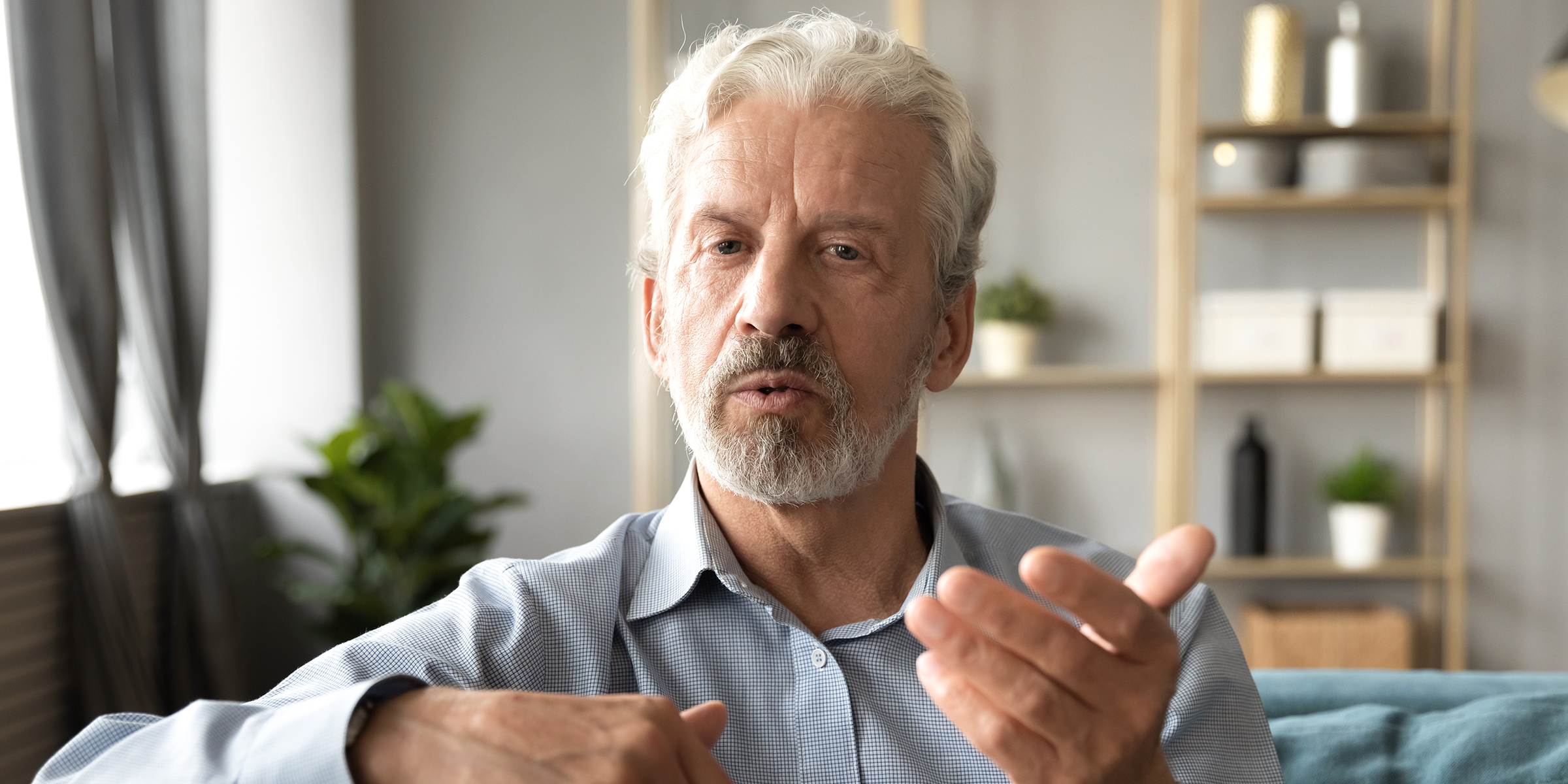 An older man speaking to someone | Source: Shutterstock