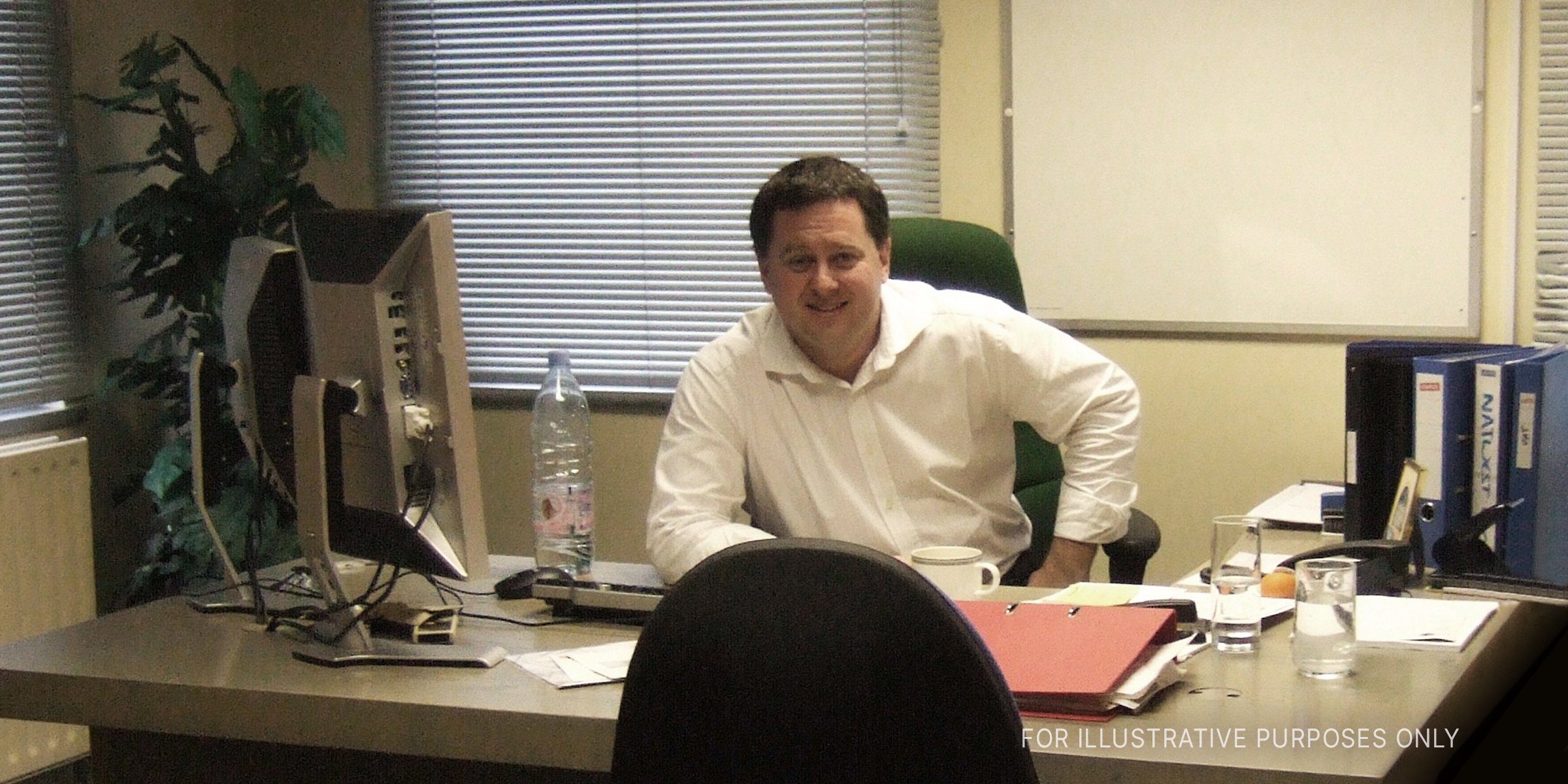 A middle-aged man sitting in his office. | Source: Flickr/foilman (CC BY-SA 2.0)