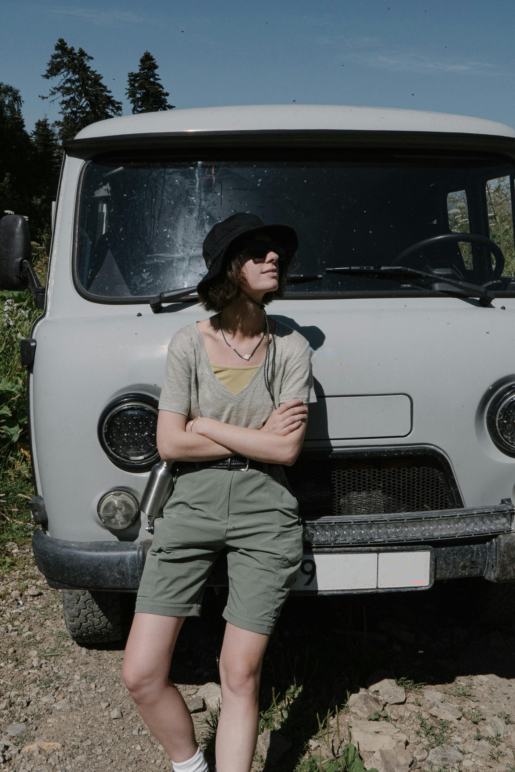 A woman with folded arms standing against a car | Source: Pexels