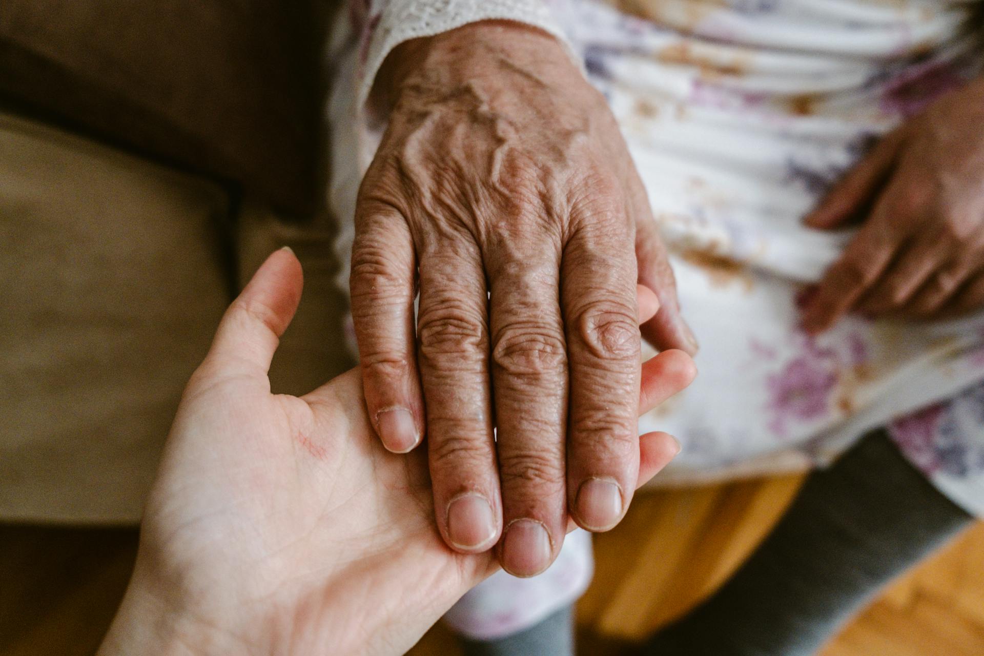 A woman holding her mother's hand | Source: no source