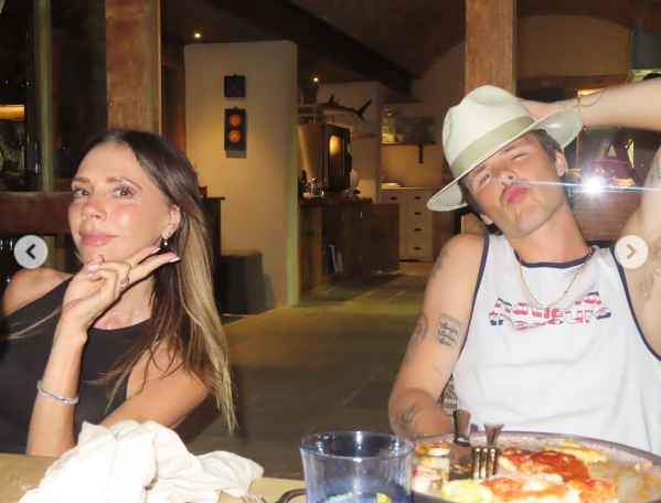 Victoria and Cruz Beckham pose while having dinner during the summer in a post dated September 1, 2025 | Source: Instagram/victoriabeckham