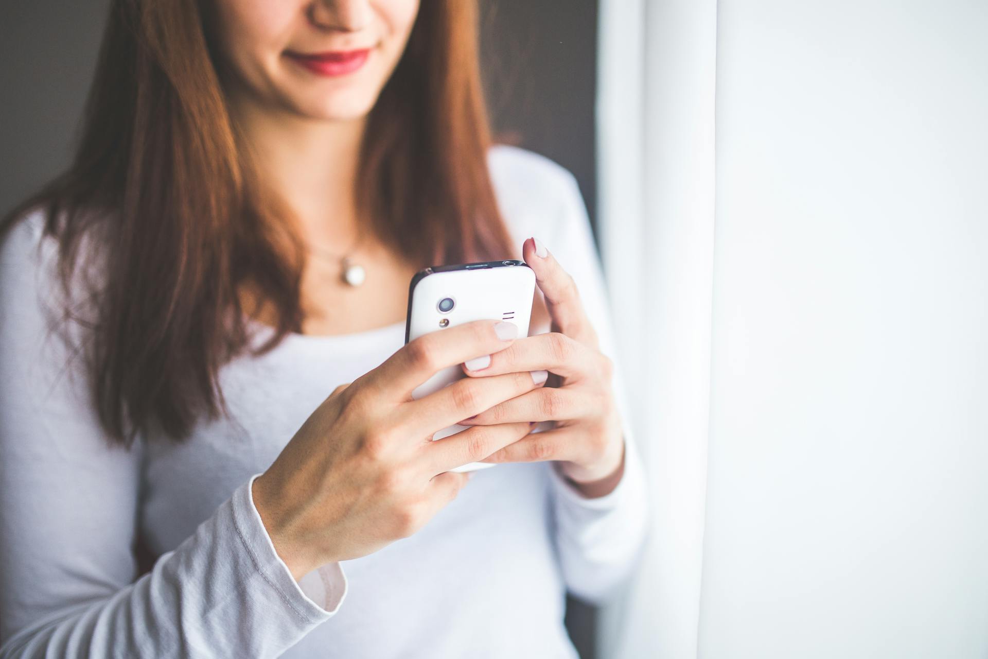 A relieved woman looking at her phone | Source: Pexels