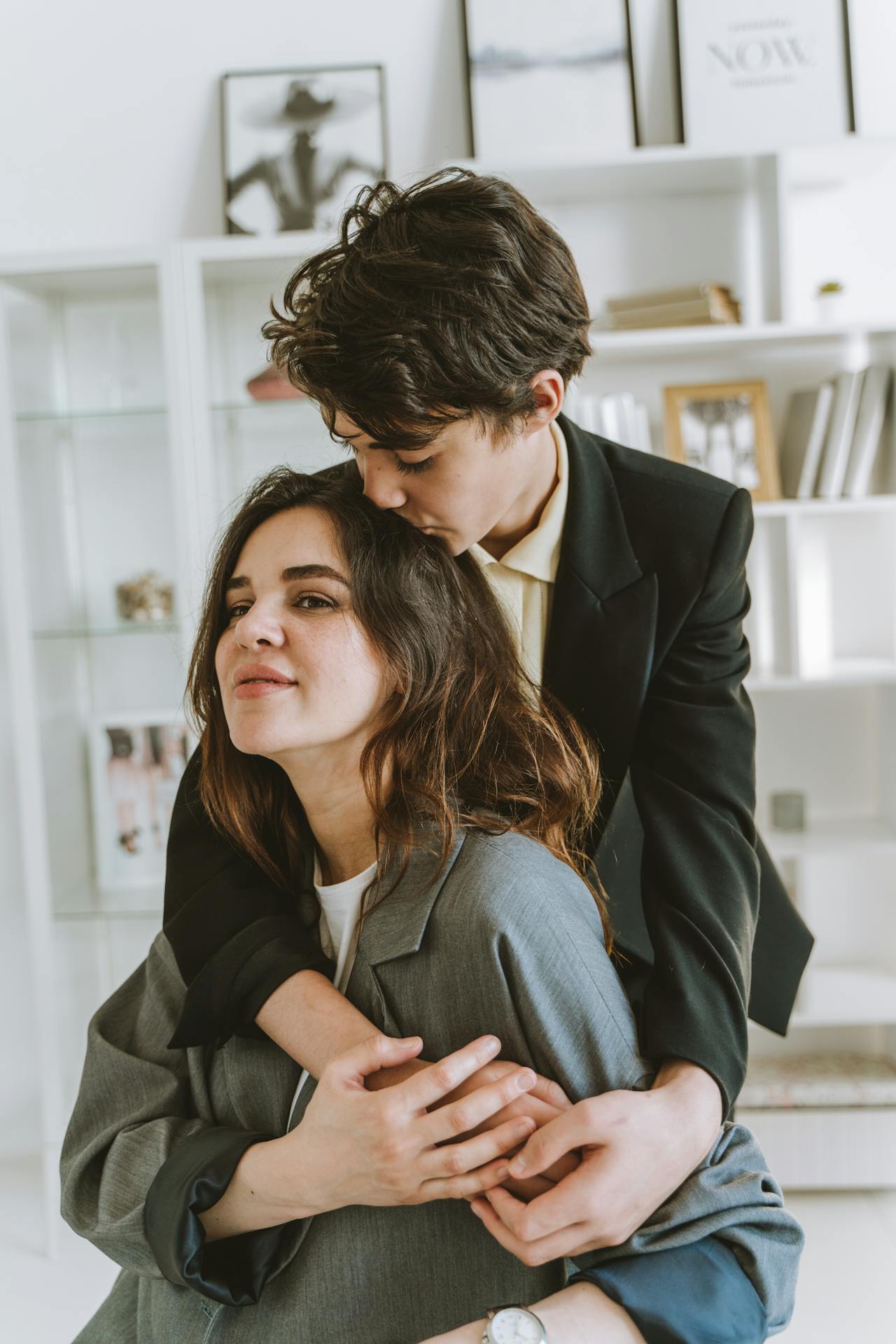 An affectionate son kissing his mother on her head | Source: Pexels