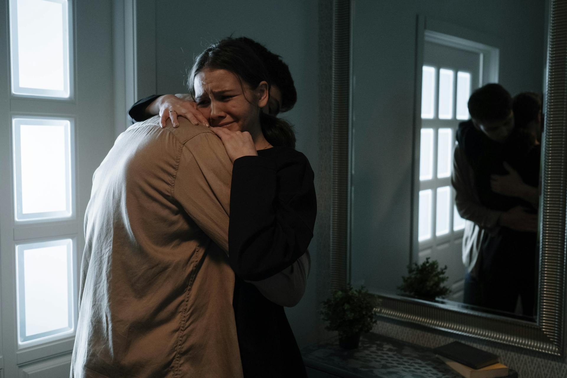 A woman cries while hugging a man | Source: Pexels