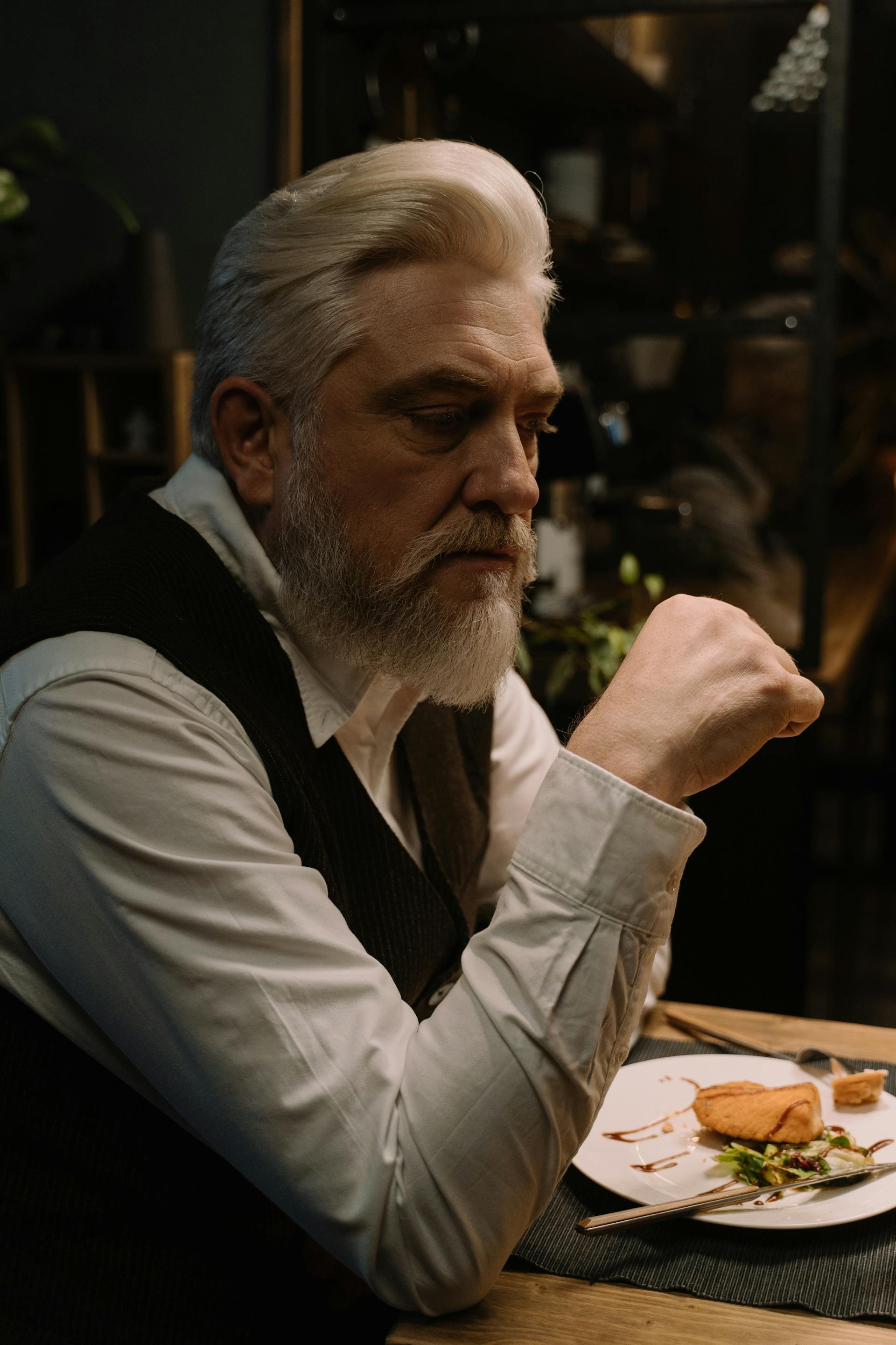 A man seated at a dinner table | Source: Pexels