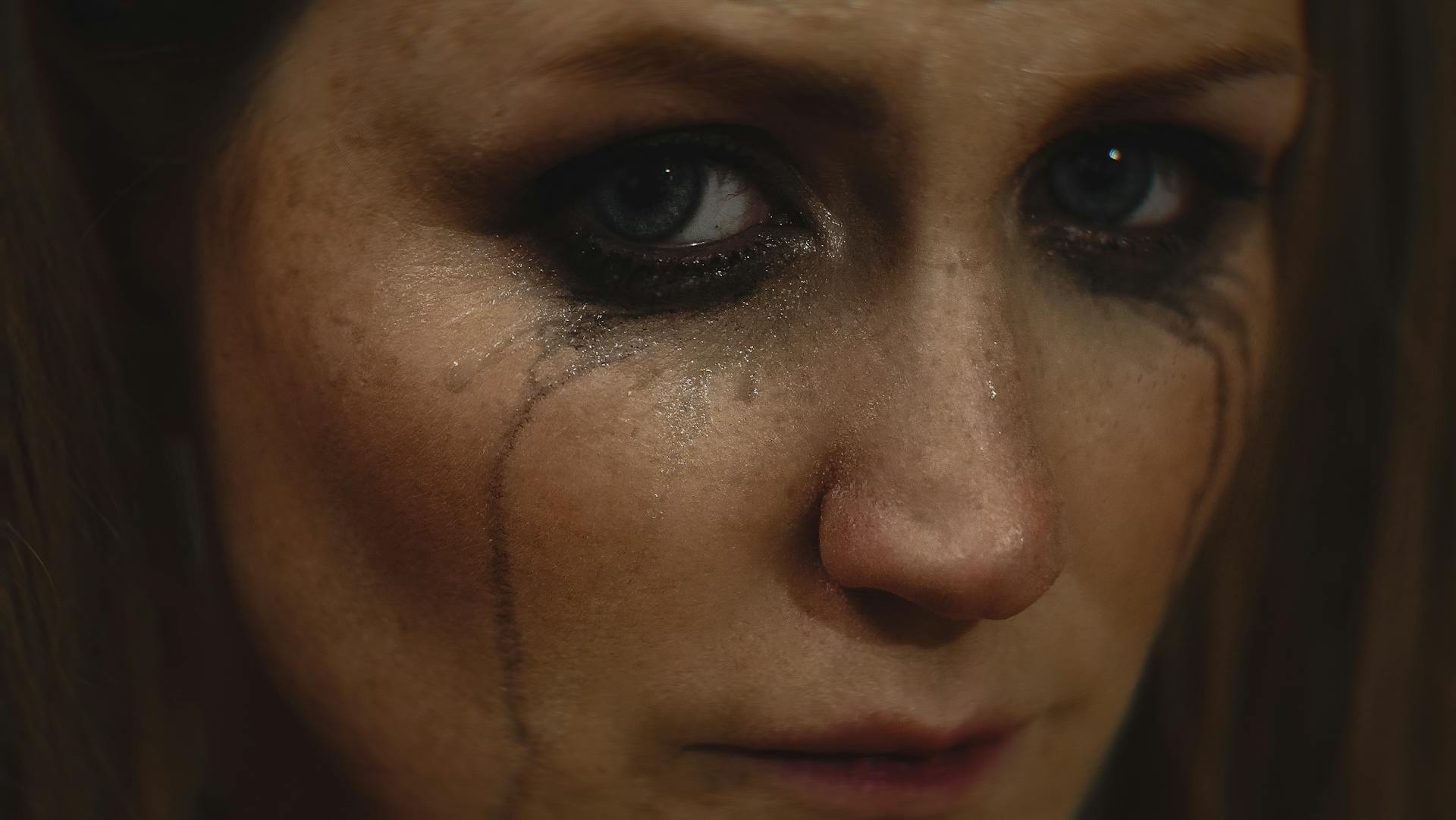 An emotional woman with messy eyeliner | Source: Pexels