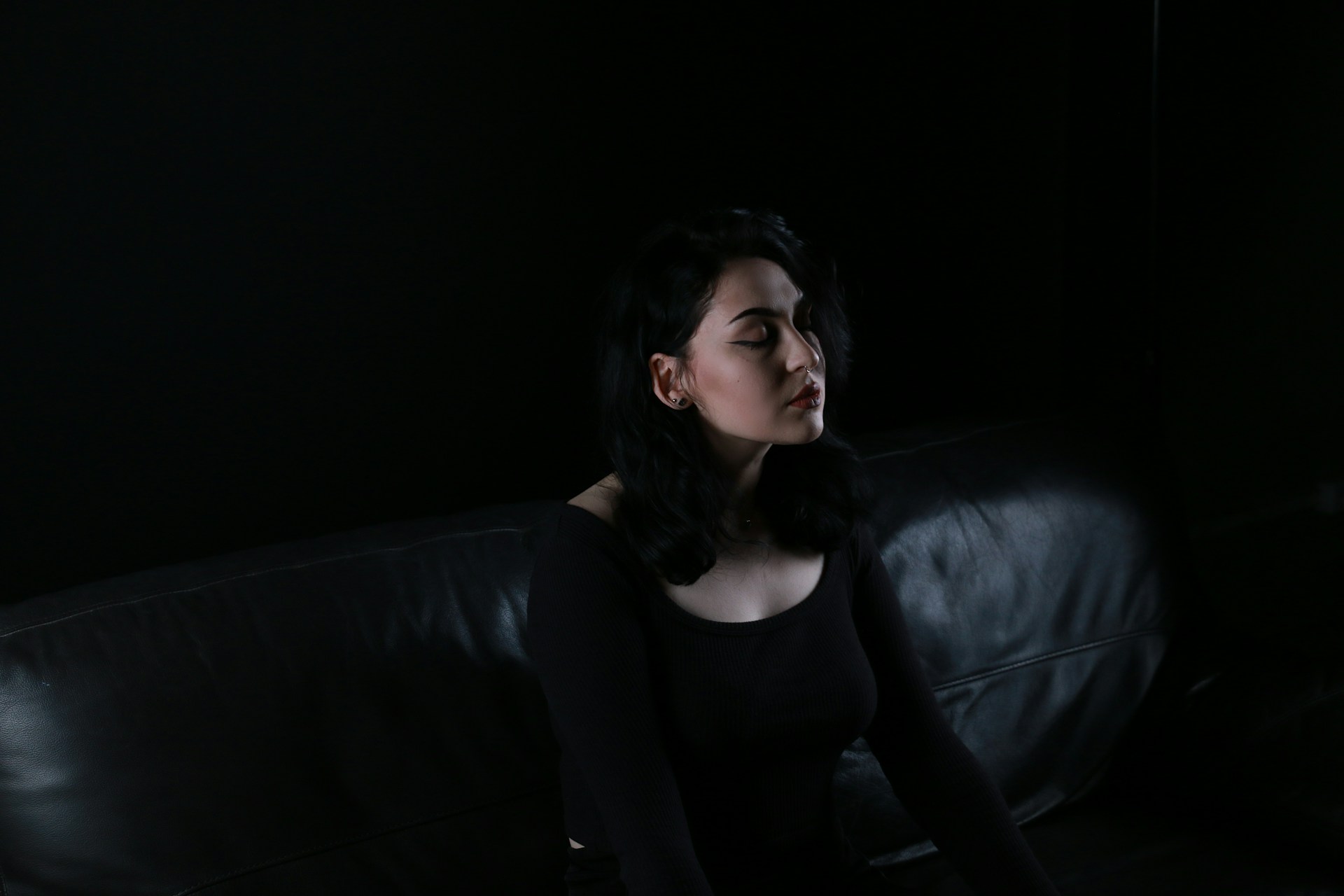 A woman sitting on a sofa | Source: Unsplash
