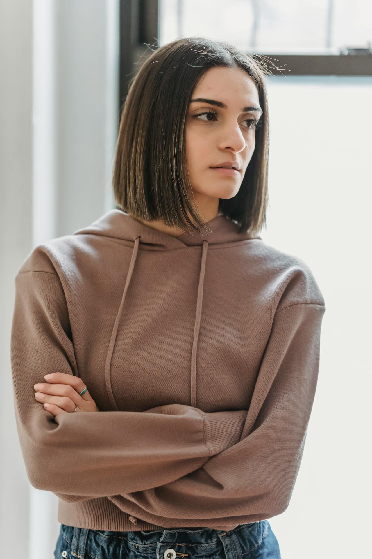 A stern-looking woman with her arms crossed | Source: Pexels