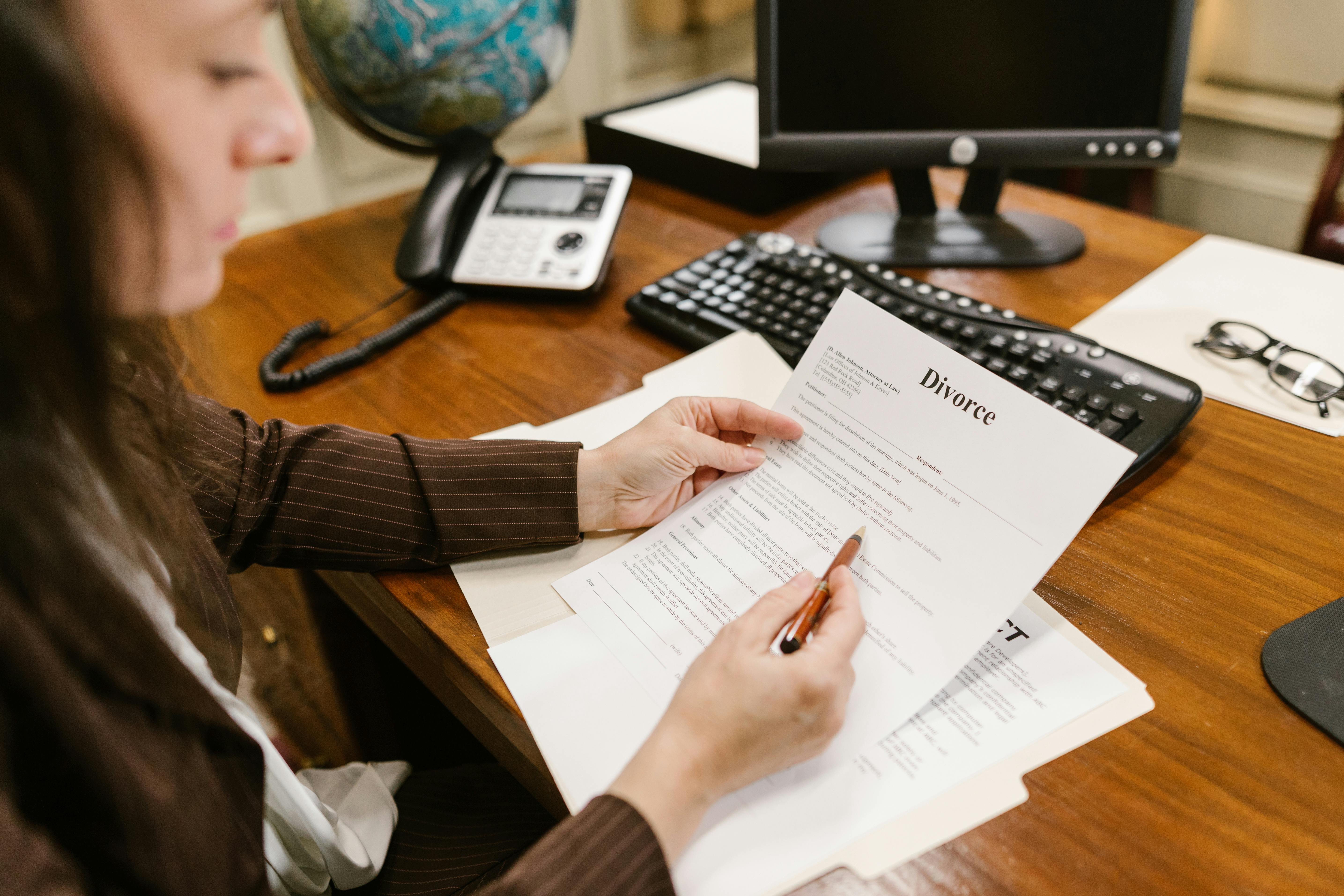 Woman holding divorce documents | Source: Pexels