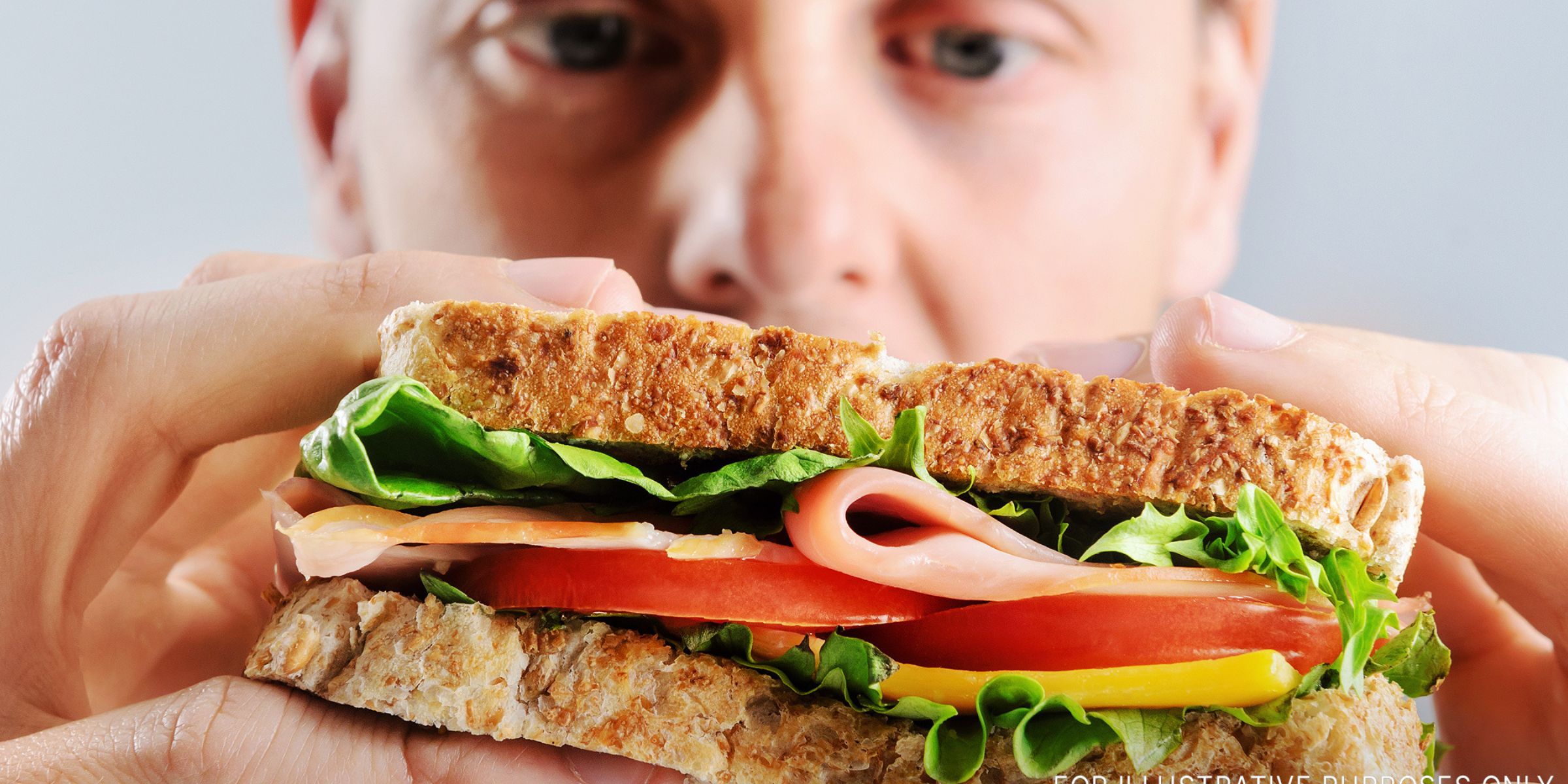 A man looking at a sandwich | Source: Shutterstock