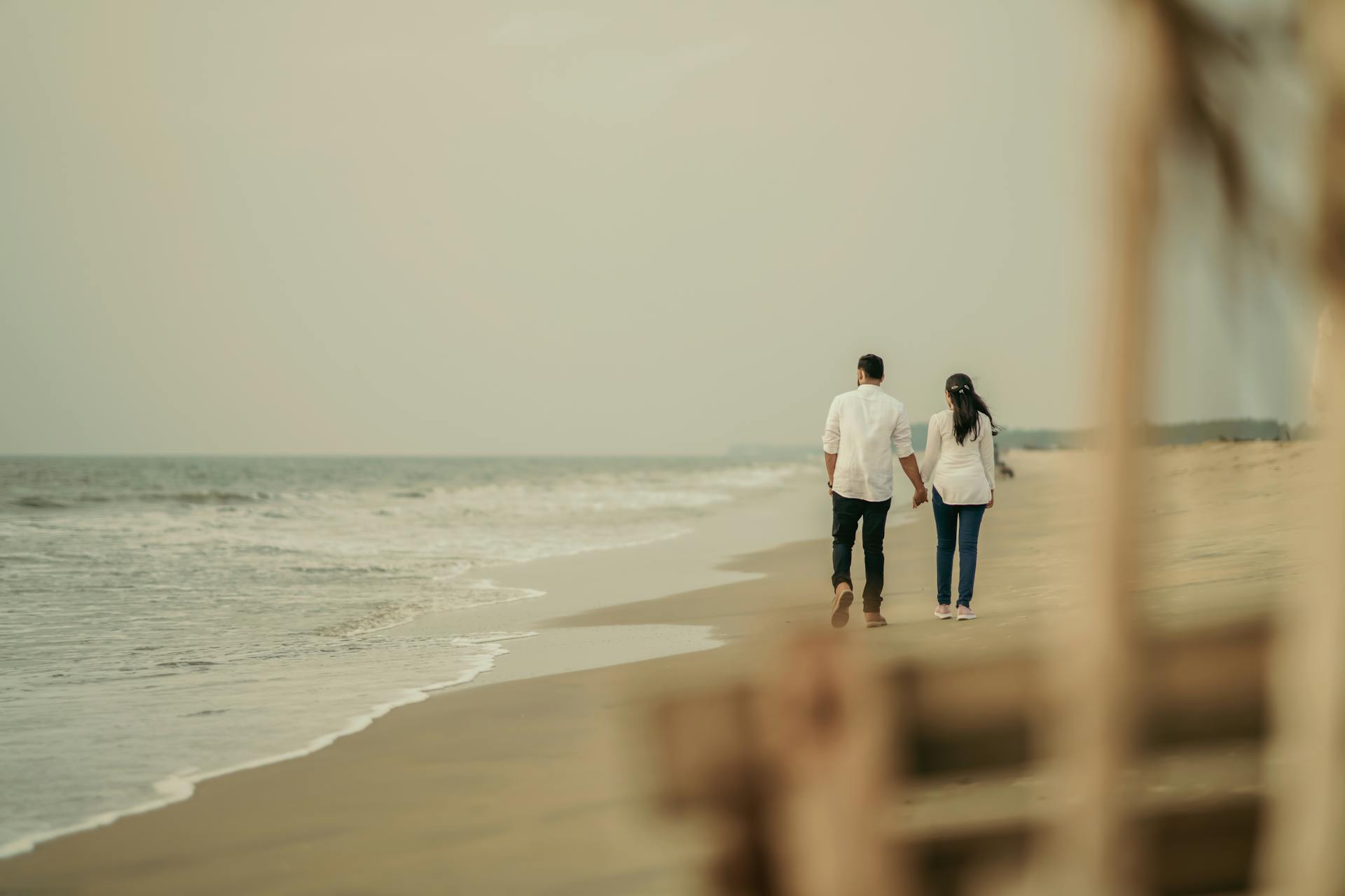 A couple walking on the beach | Source: No source
