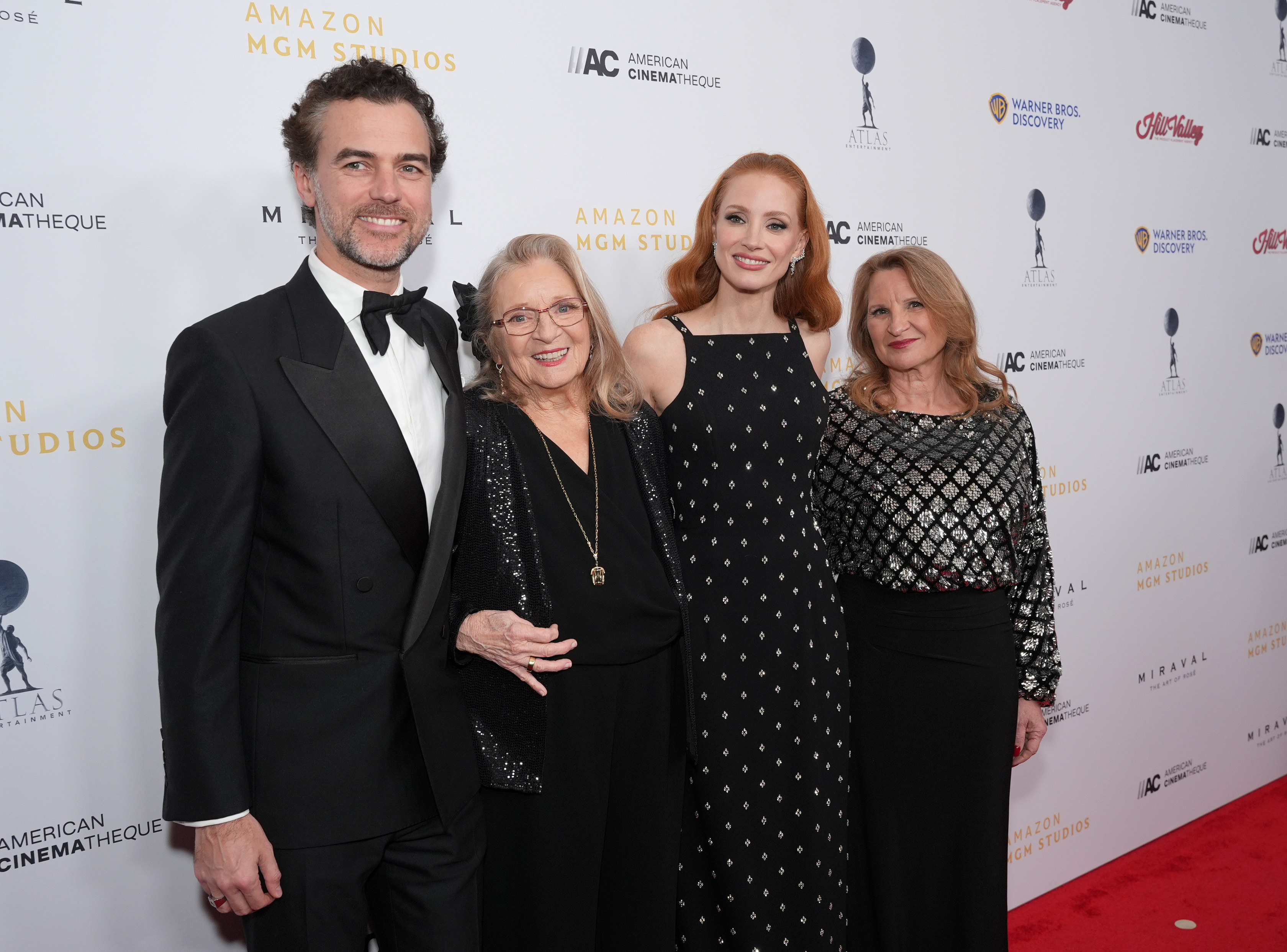 The actress (C) with her husband Gian Luca Passi de Preposulo, her grandmother Marilyn Herst, and her mother Jerri Chastain attend the 38th Annual American Cinematheque Awards at The Beverly Hilton on December 6, 2024 in Beverly Hills, California. | Source: Getty Images