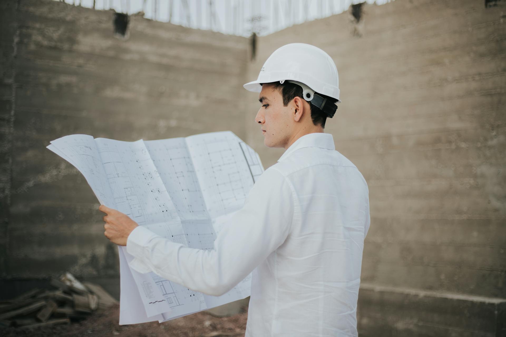 An architect examining a plan layout | Source: Pexels