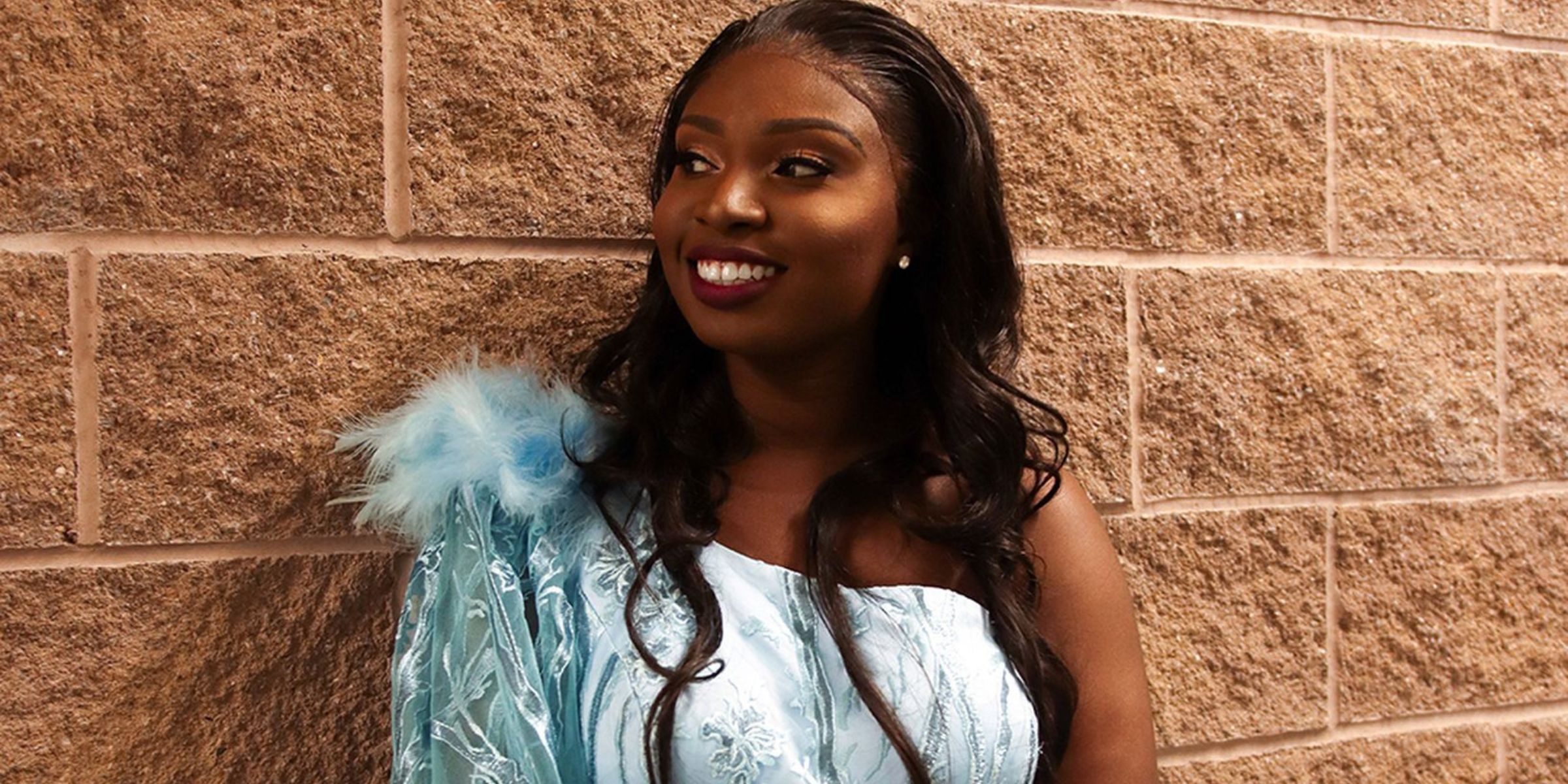 A young woman in a prom dress | Pexels