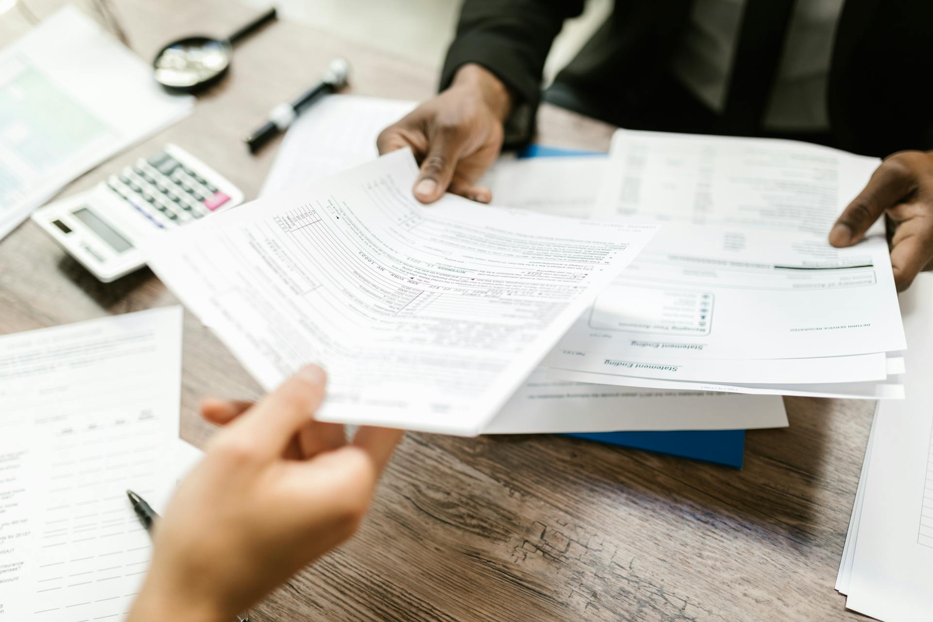 A man and a woman reviewing documents in an office | Source: Pexels
