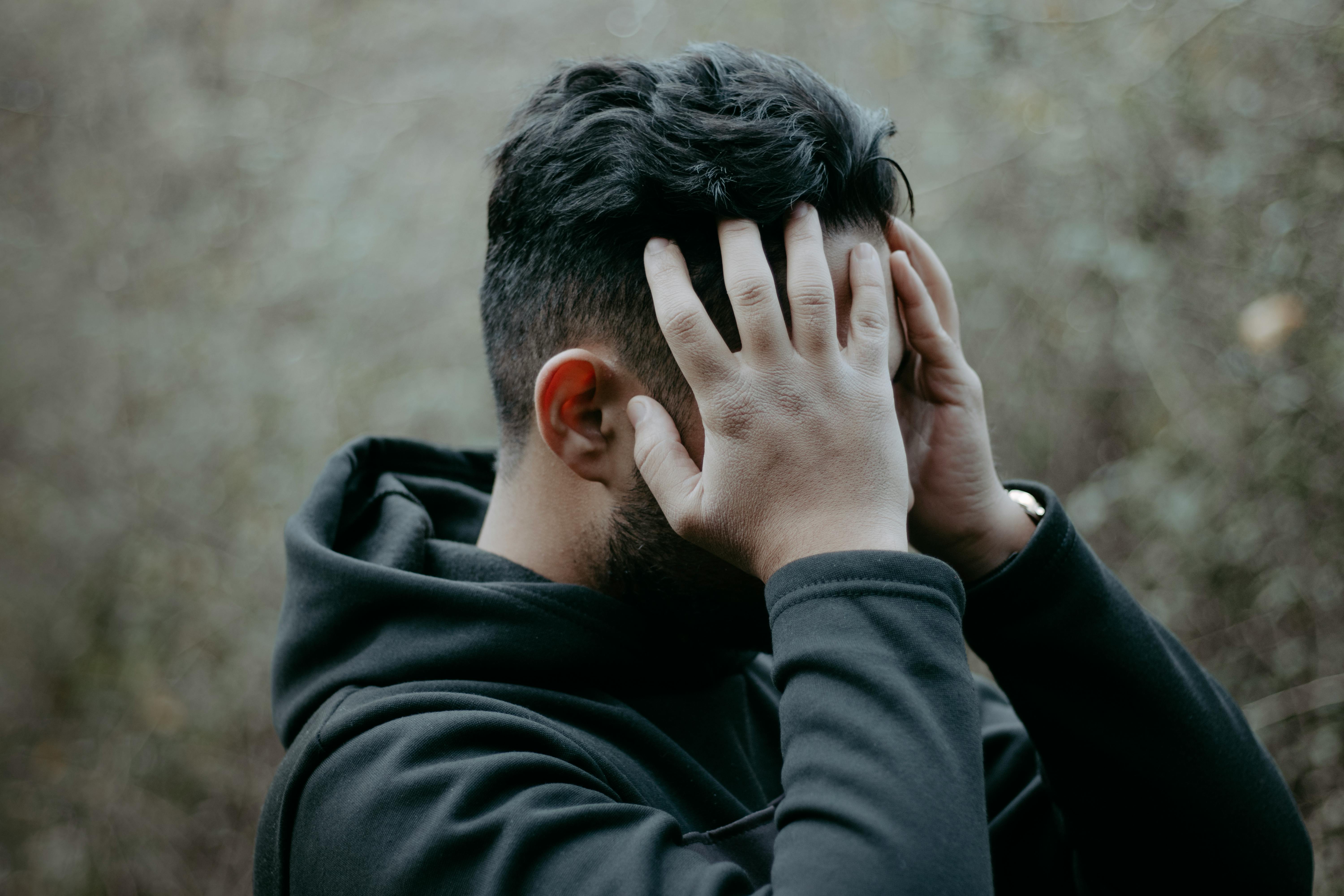 Worried older man holding head