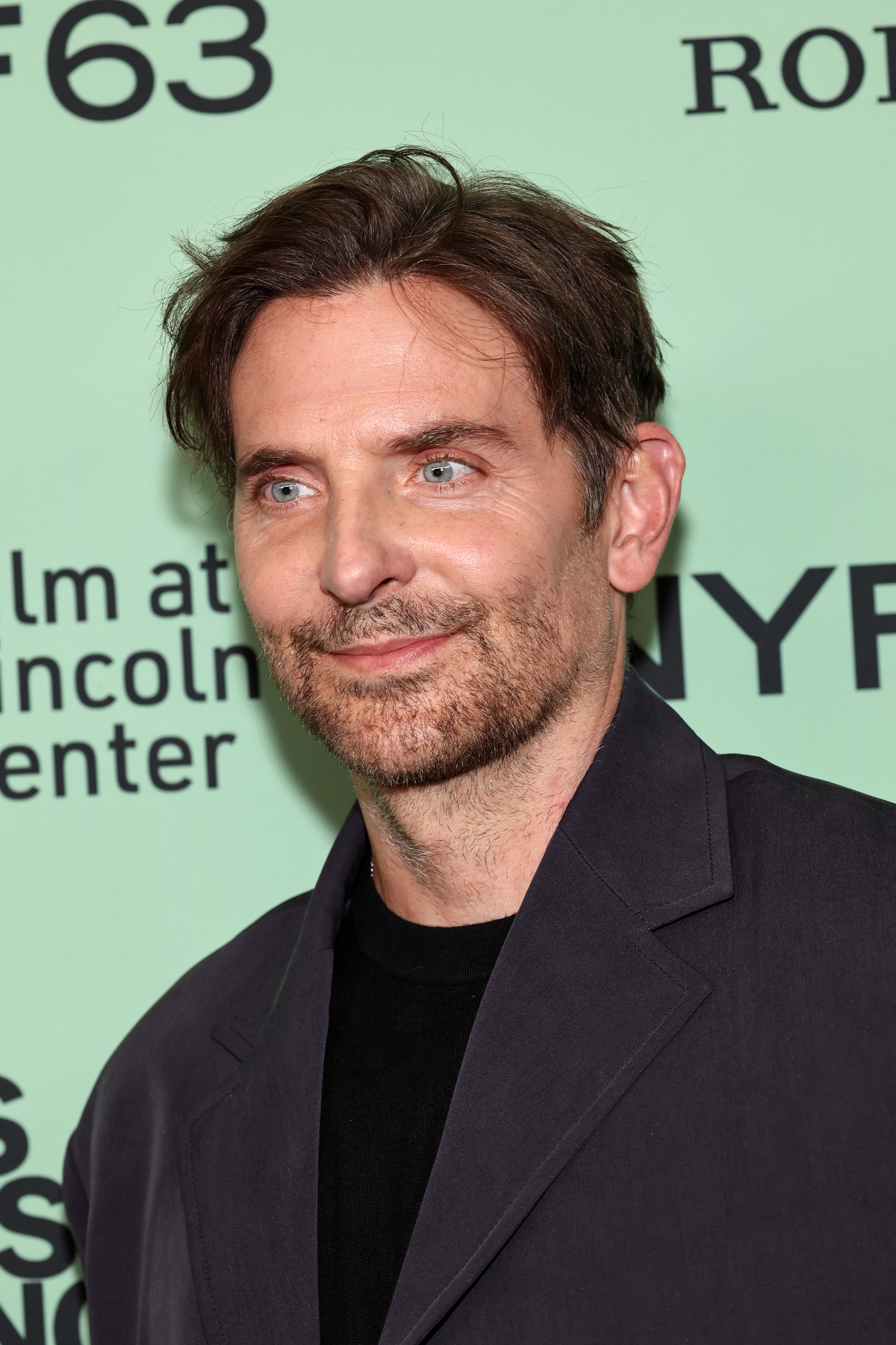 In his most recent shots, Cooper was seen with a subtle smile and with just a few fine lines tracing the outer corners of his eyes. But his expression here gave him a slightly puzzling appearance. This was the premiere for "Is This Thing On?" during the 63rd New York Film Festival at Alice Tully Hall on October 10, 2025, in New York City.