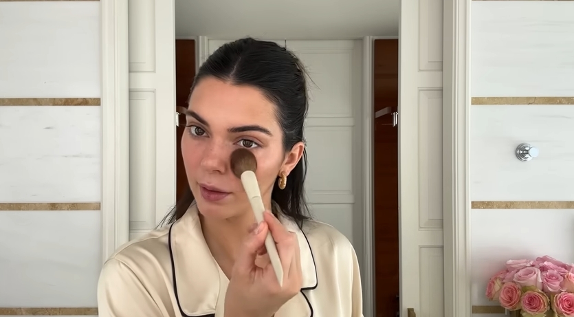 Kendall Jenner doing her Spring French girl makeup routine from a post dated April 11, 2024. | Source: YouTube\Vogue