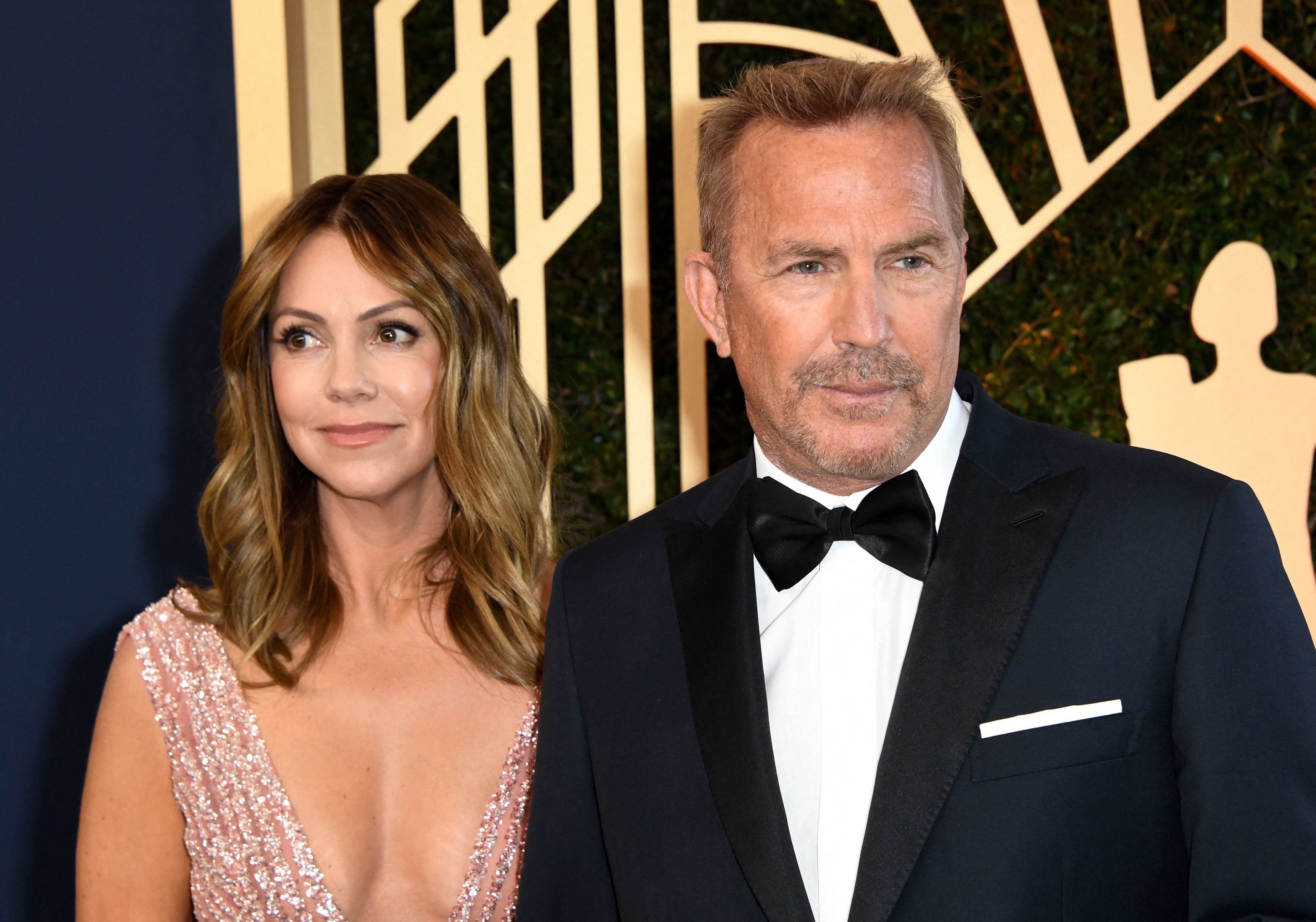 Kevin Costner and Christine Baumgartner arrive for the 28th Annual Screen Actors Guild (SAG) Awards on February 27, 2022 | Source: Getty Images