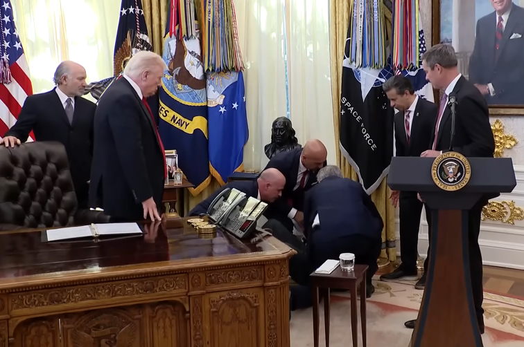 President Donald Trump looks on as executives at the White House help guest who collapsed on November 6, 2025 | Source: Youtube/The Sun