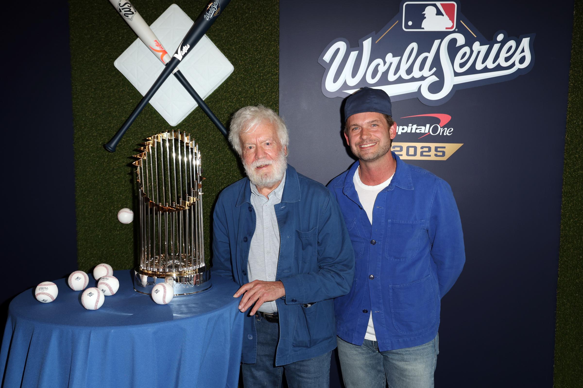 Patrick J. Adams posing for a photo with someone at the sports event. | Source: Getty Images