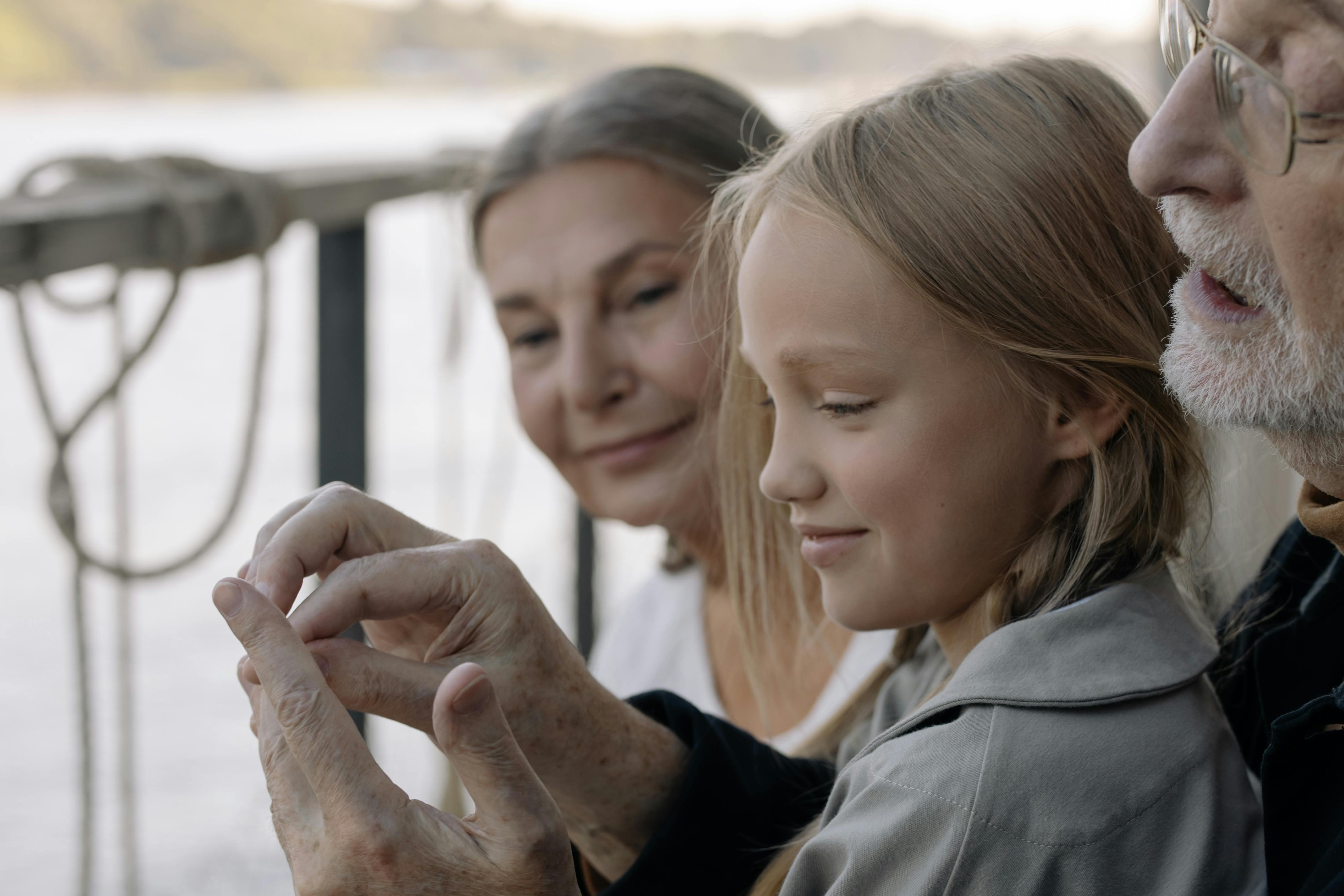 Happy grandparents with their granddaughter | Source: Pexels