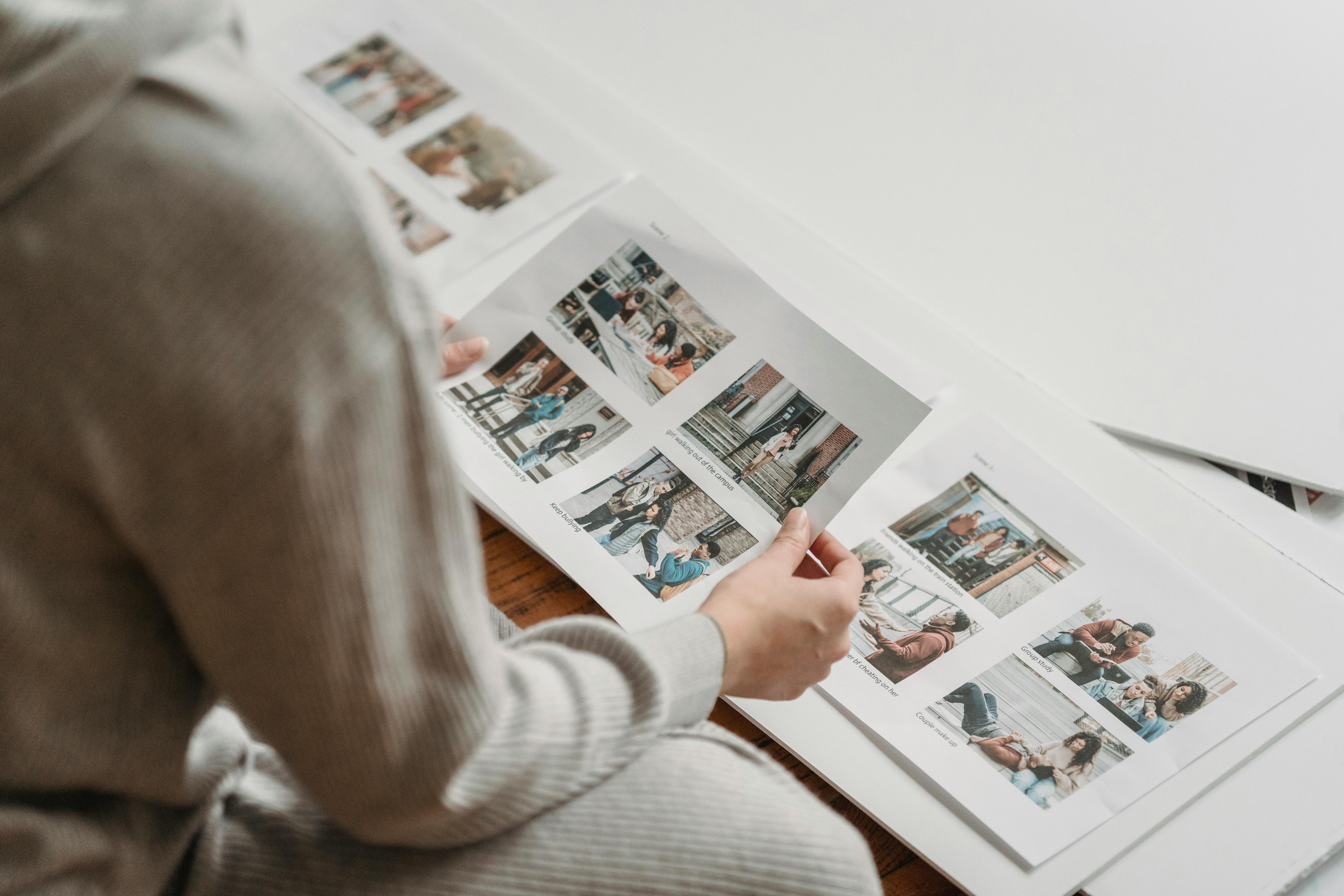 A person looking through printed photos | Source: Pexels